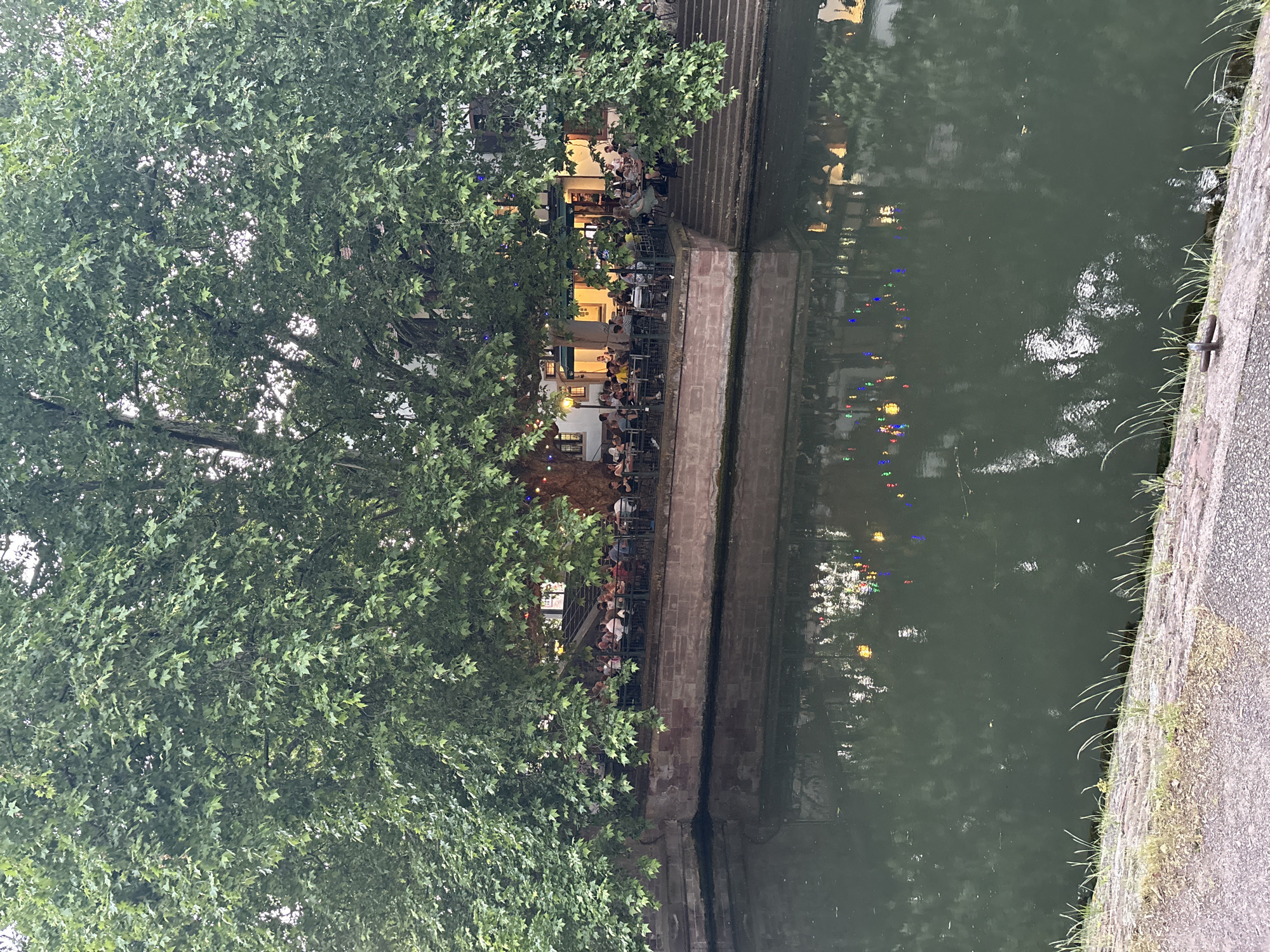 Evening diners gather at Strasbourg canal-side restaurant
