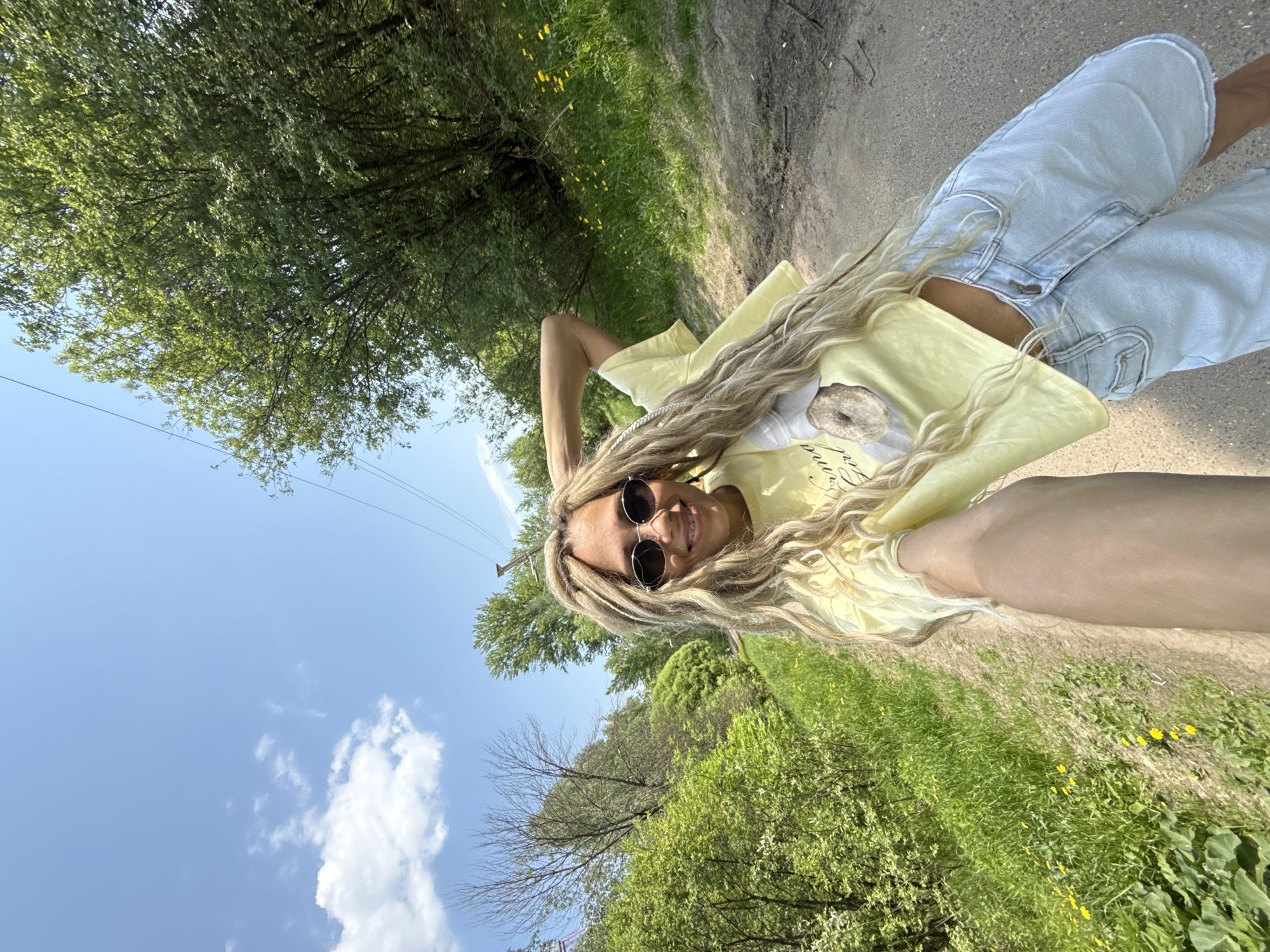 Woman poses for selfie on woodland path in Rusanovo