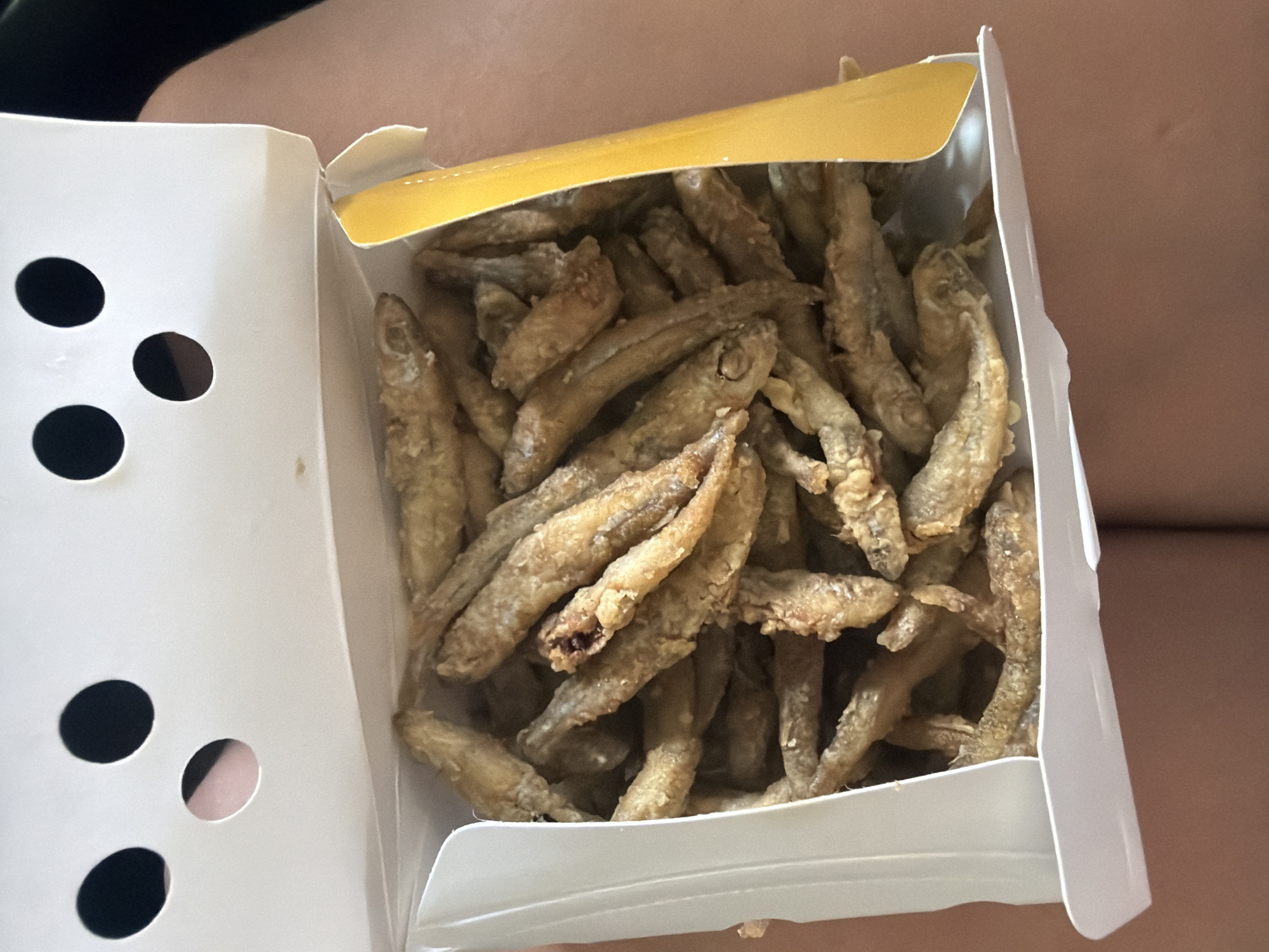Fresh fried small fish served in a paper box, Strovolos