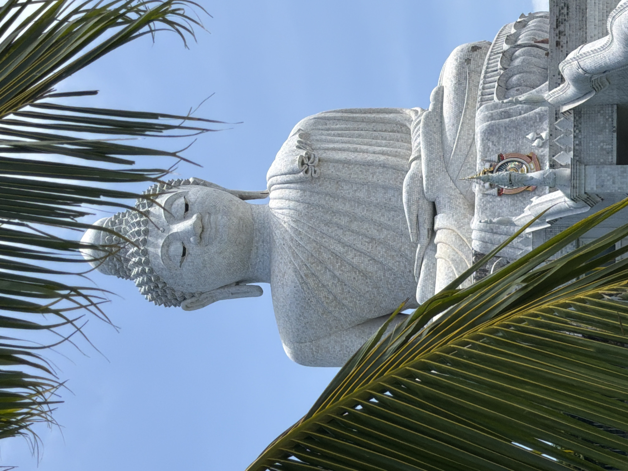 White Buddha statues overlooking Karon on a clear summer morning