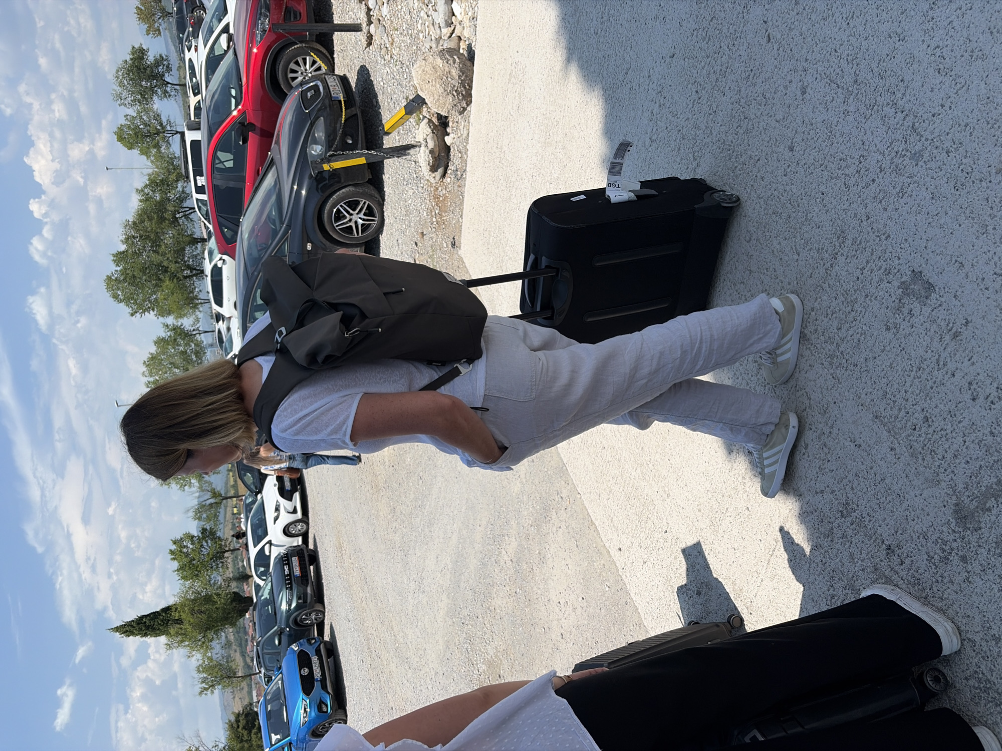 Group with luggage meets up in Podgorica parking lot