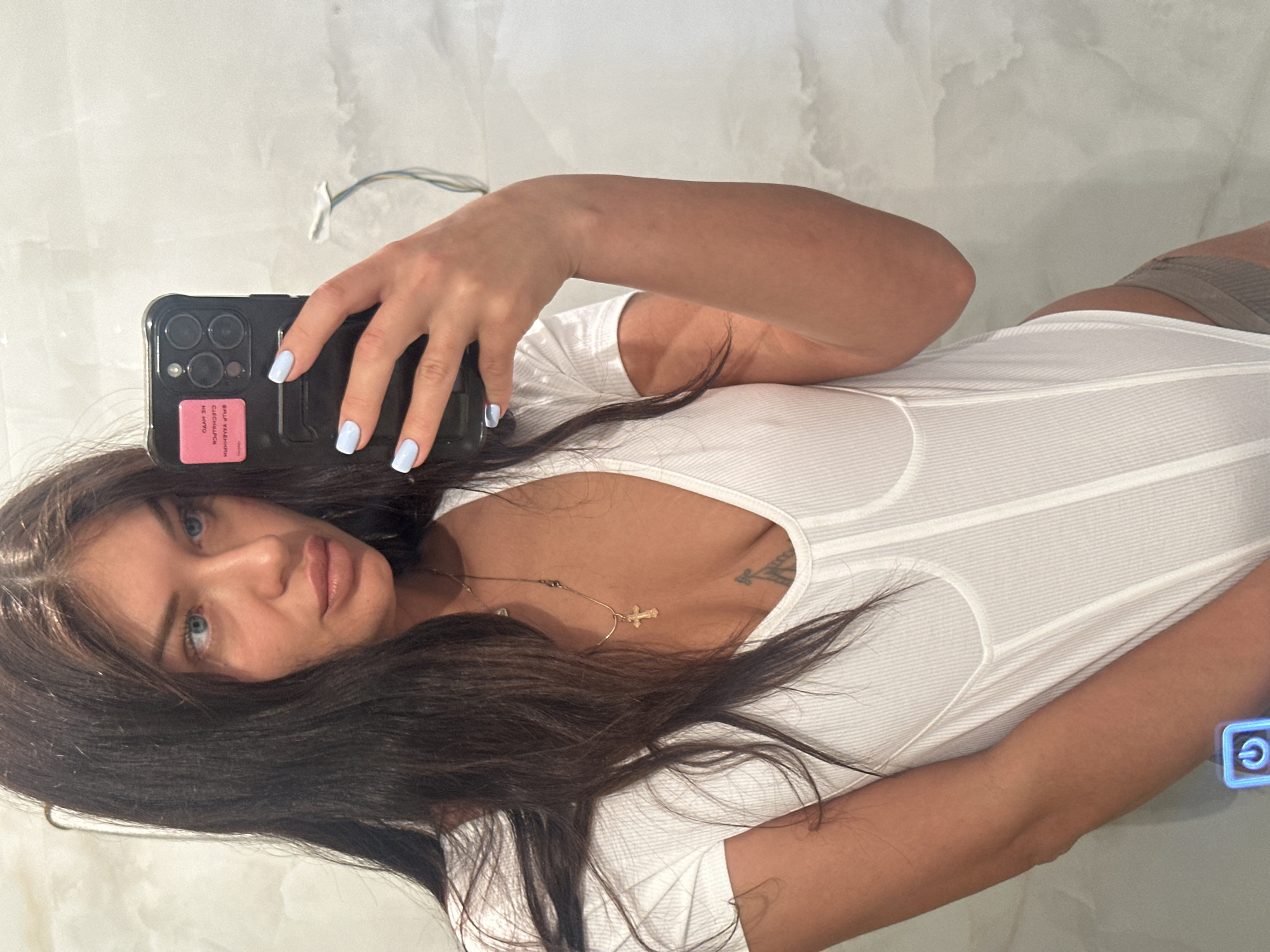 Woman takes mirror selfie with decorated smartphone in Moscow
