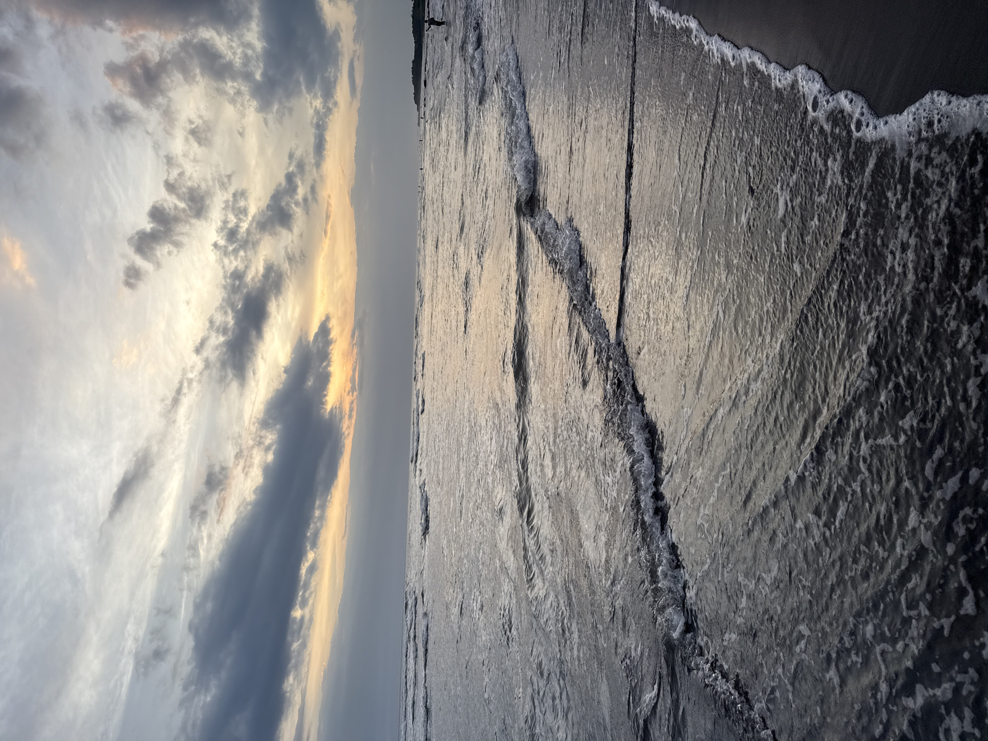 Balinese clifftop temple documented during sunset beach scene