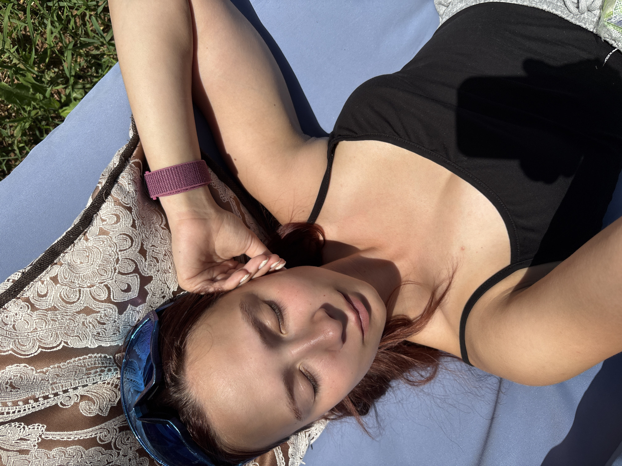 Woman relaxes on outdoor equipment in Russian garden setting