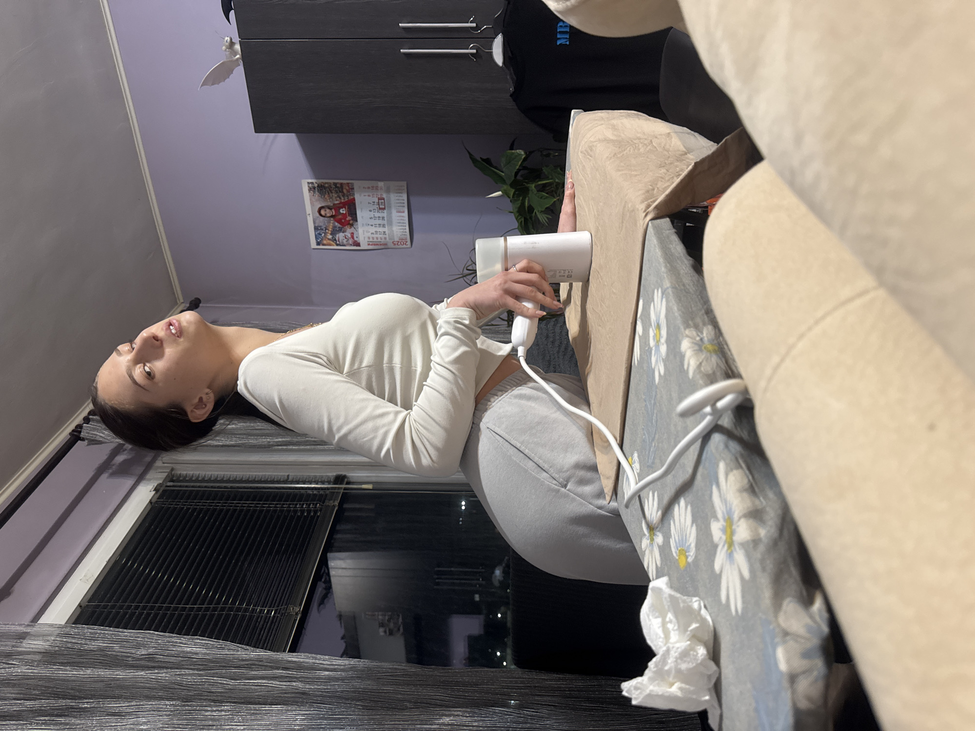 Two women relax on sofa in Sofia apartment