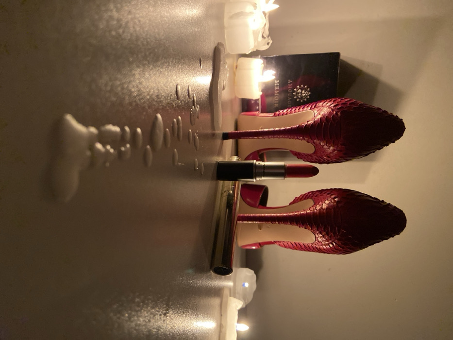 Red stilettos and makeup arranged in styled display
