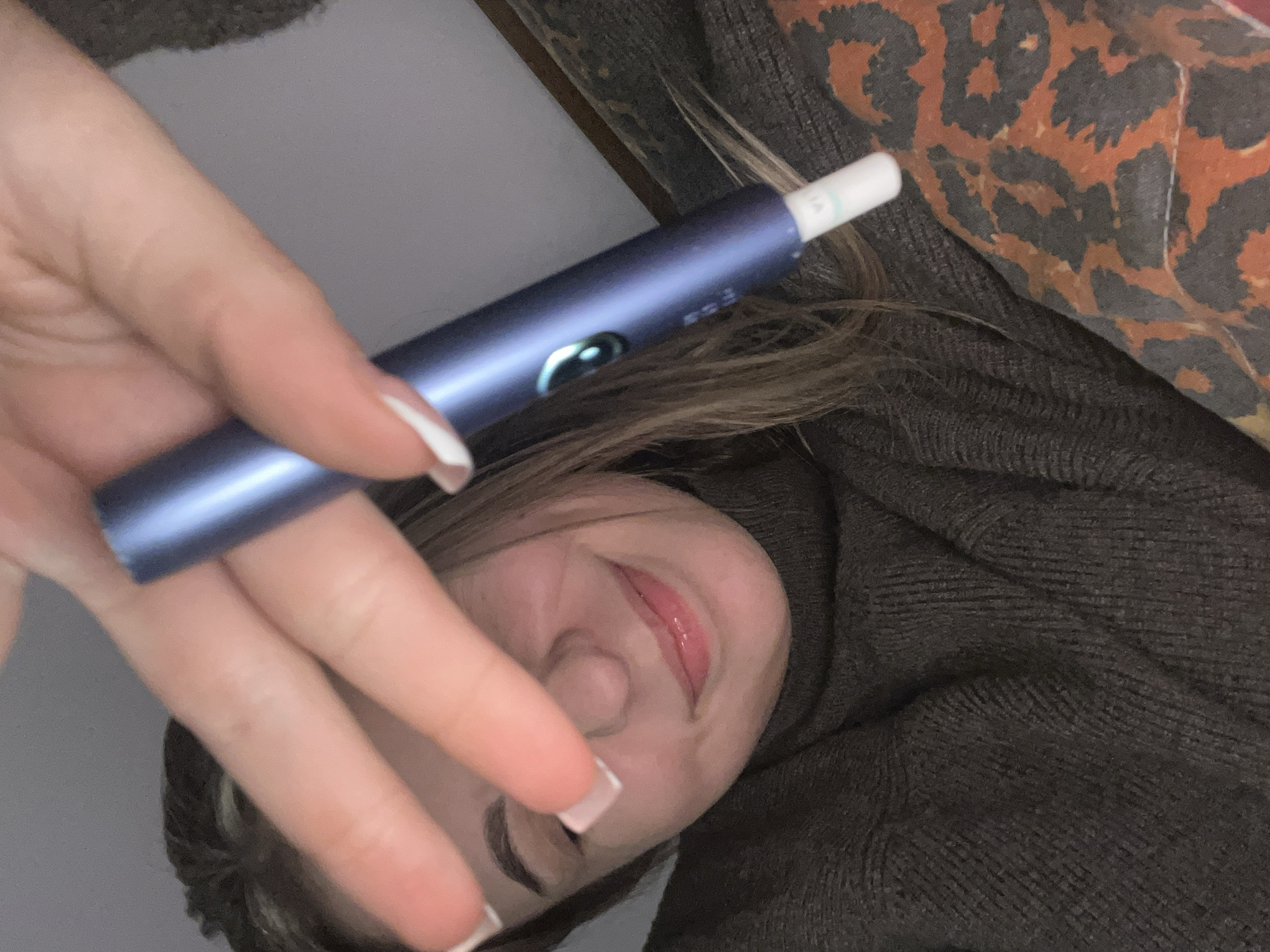 Person resting with electronic device in Varna bedroom