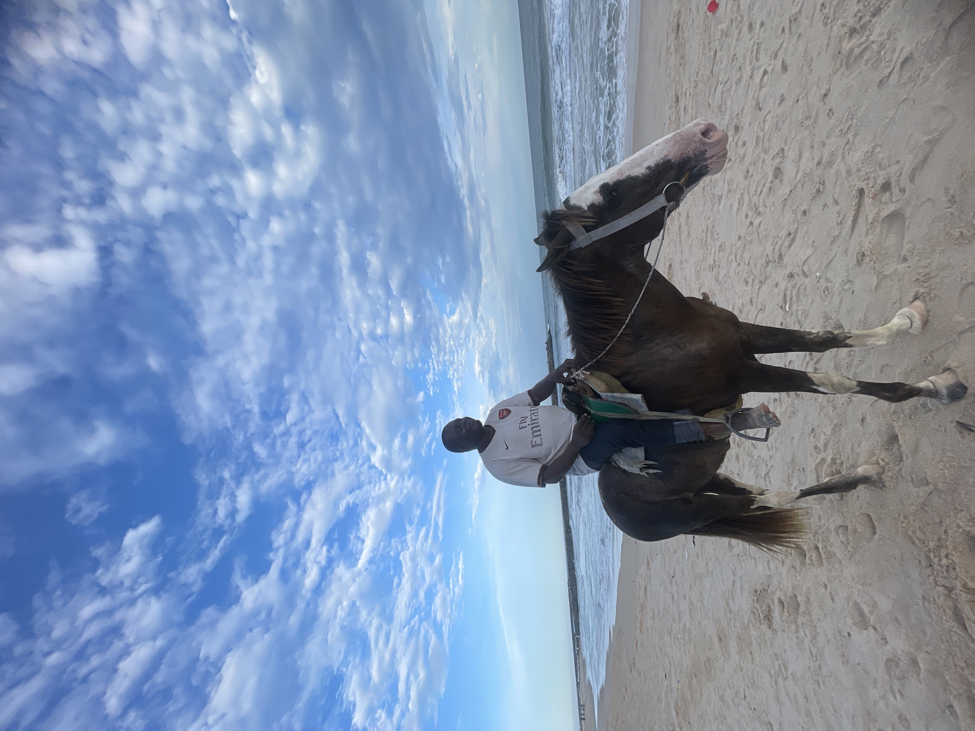 Horseback riders and vendors enjoy afternoon at Nigerian beaches