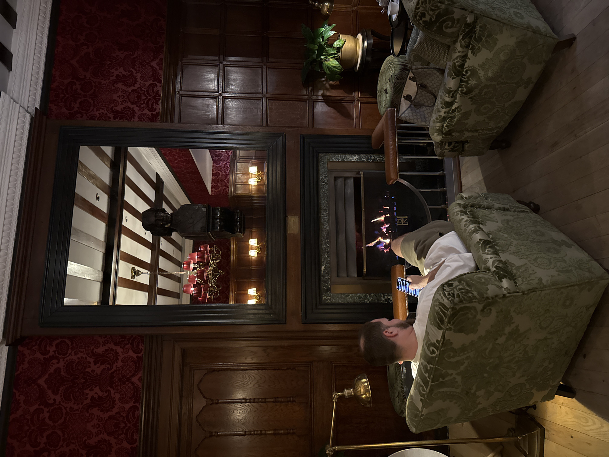 Interior space with dark wood paneling documented by witness