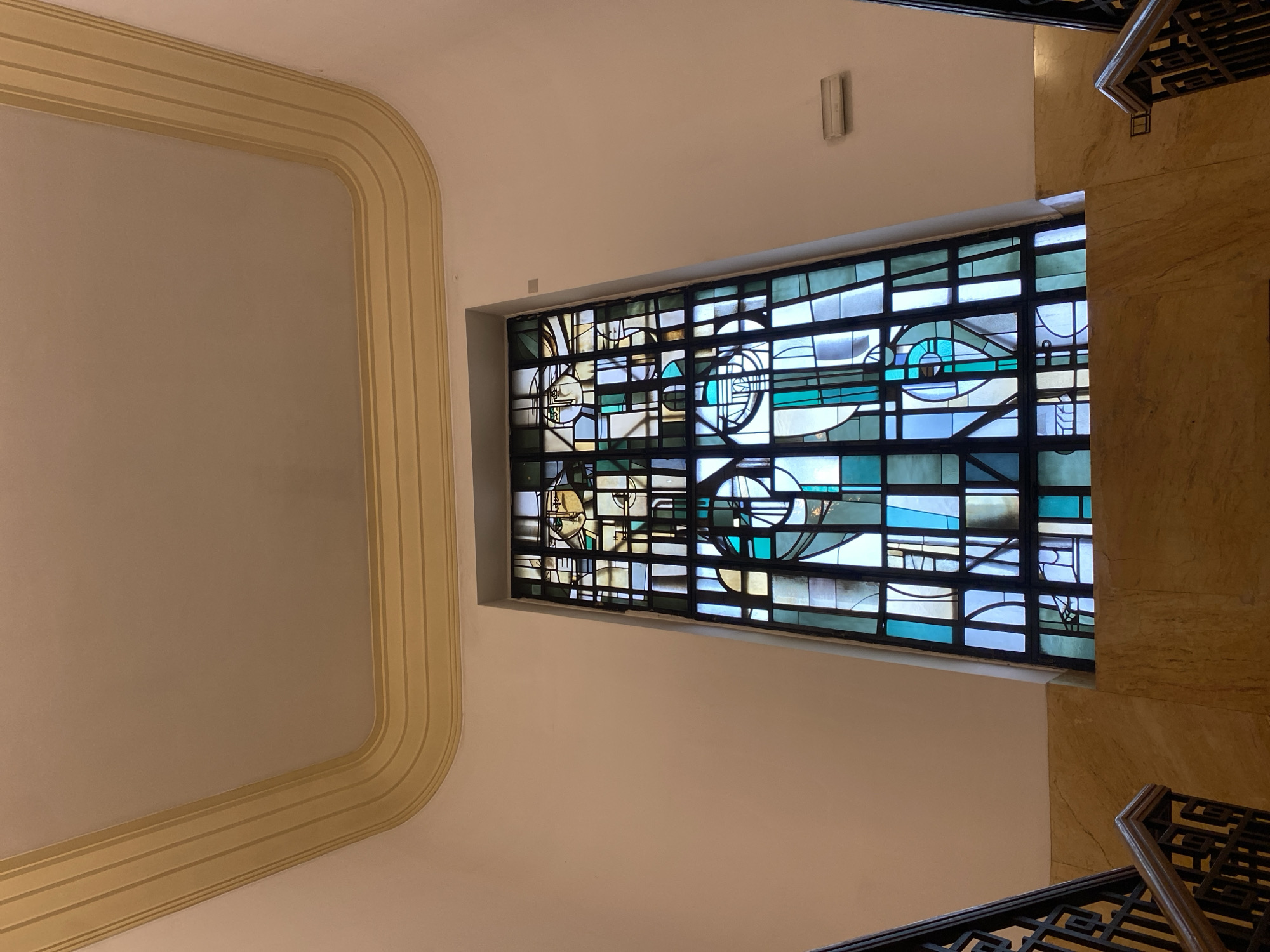 Geometric stained glass window documented in Belgrade interior space
