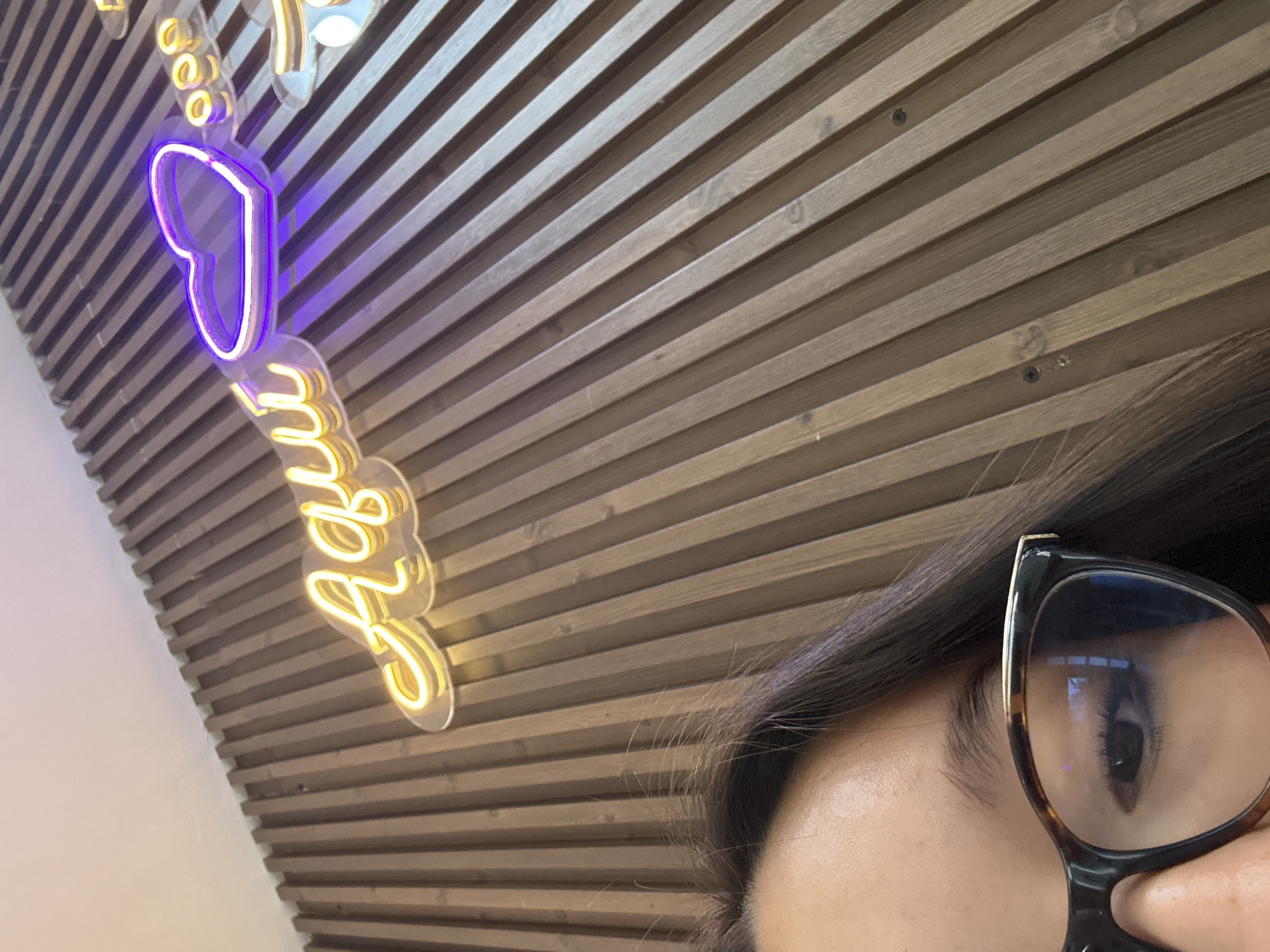 Person photographed with neon heart sign in Acapulco