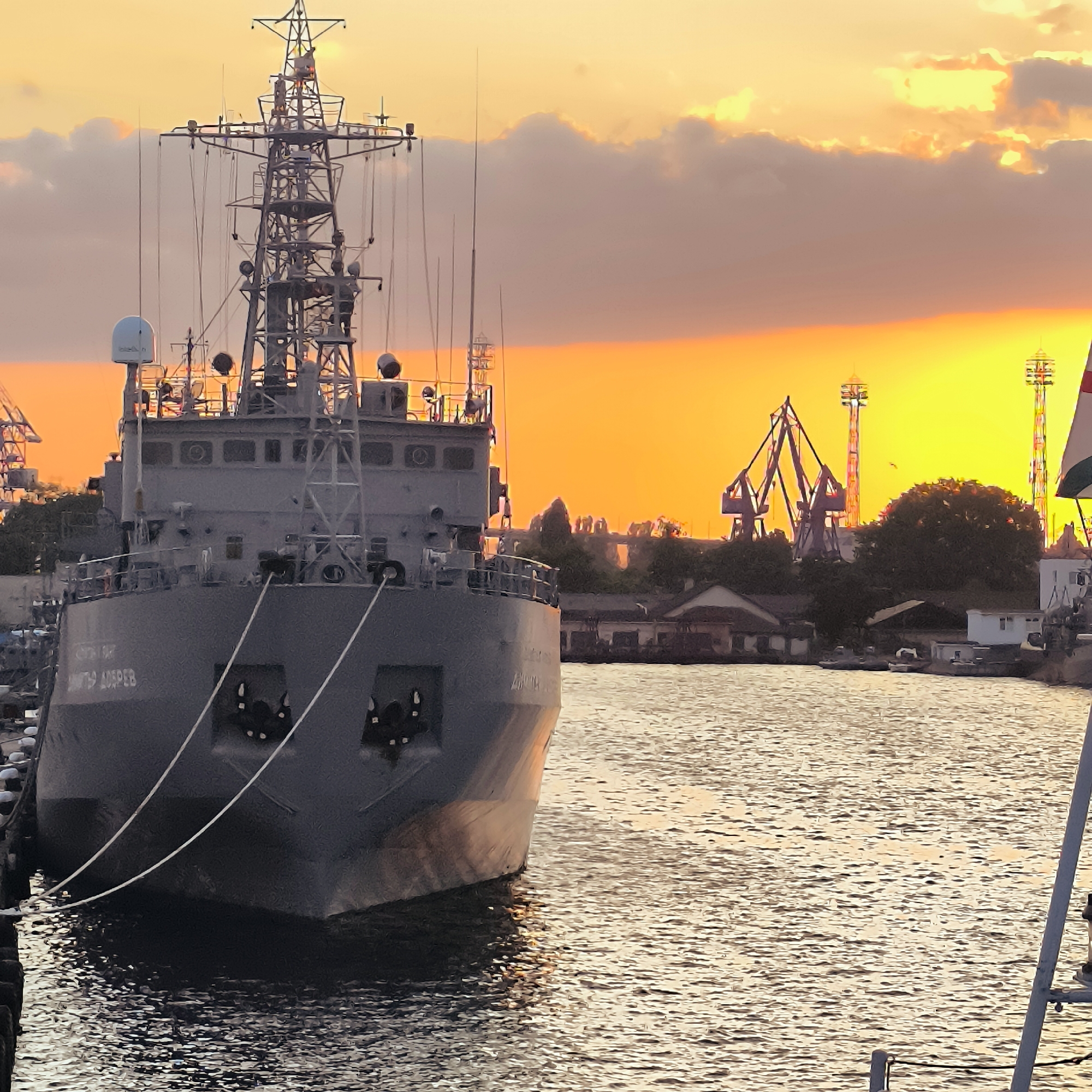 Varna Port at sunset: naval ships, working boats, and sailboats