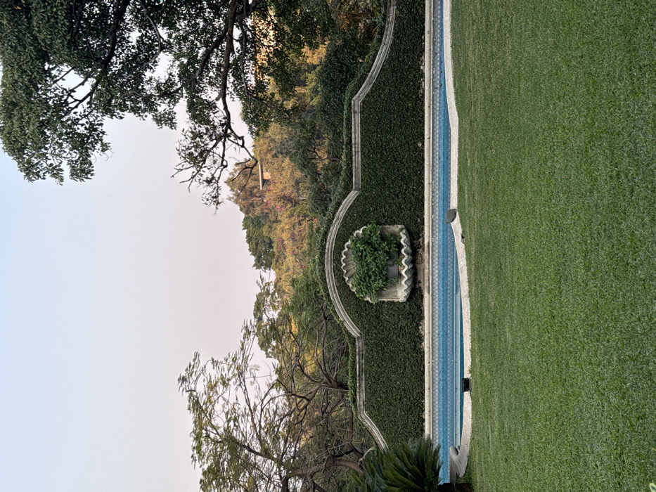 Evening gathering at Cuernavaca property features dining, landscaping