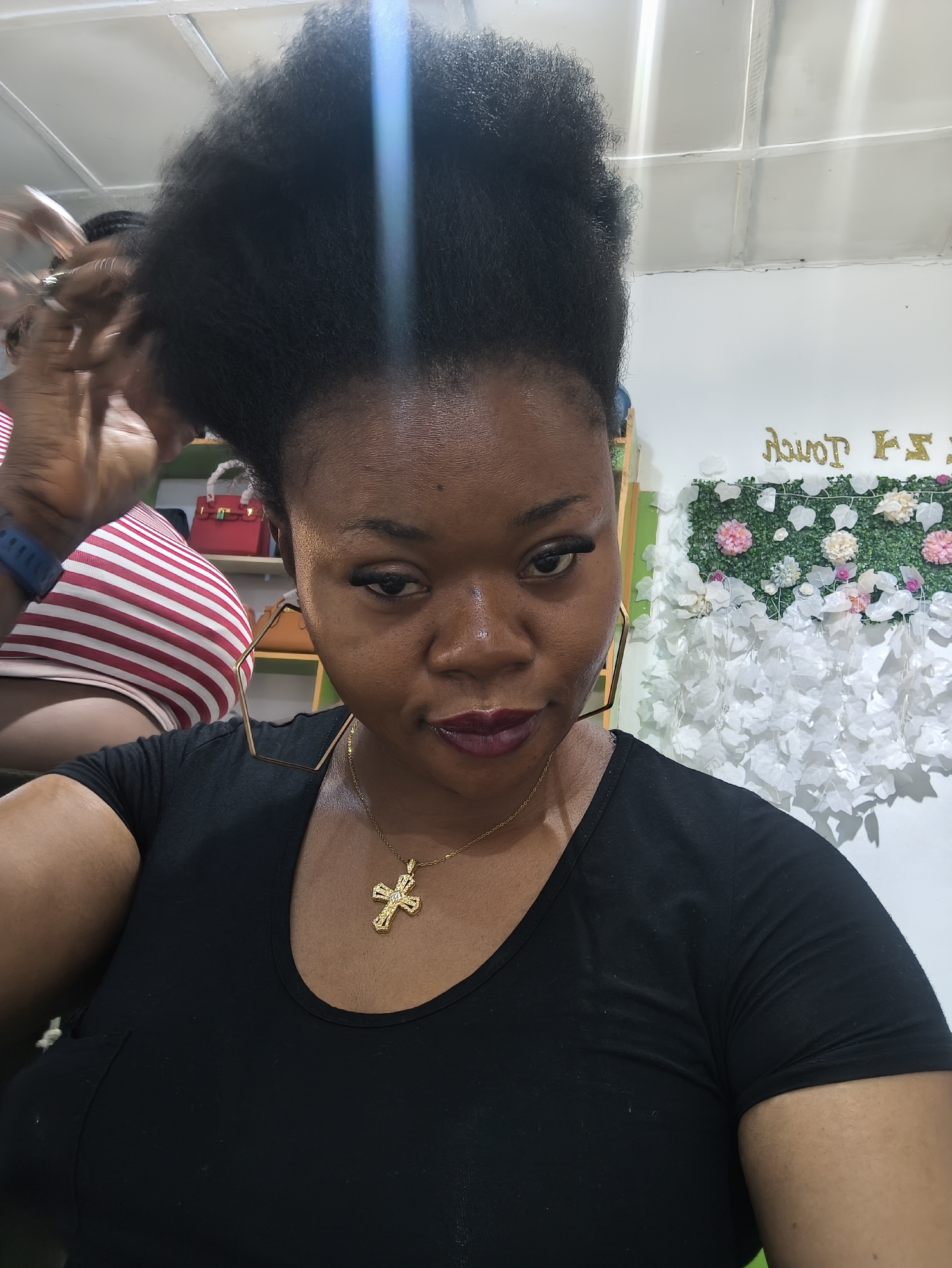 Woman takes selfie at beauty salon in Kabong, Nigeria