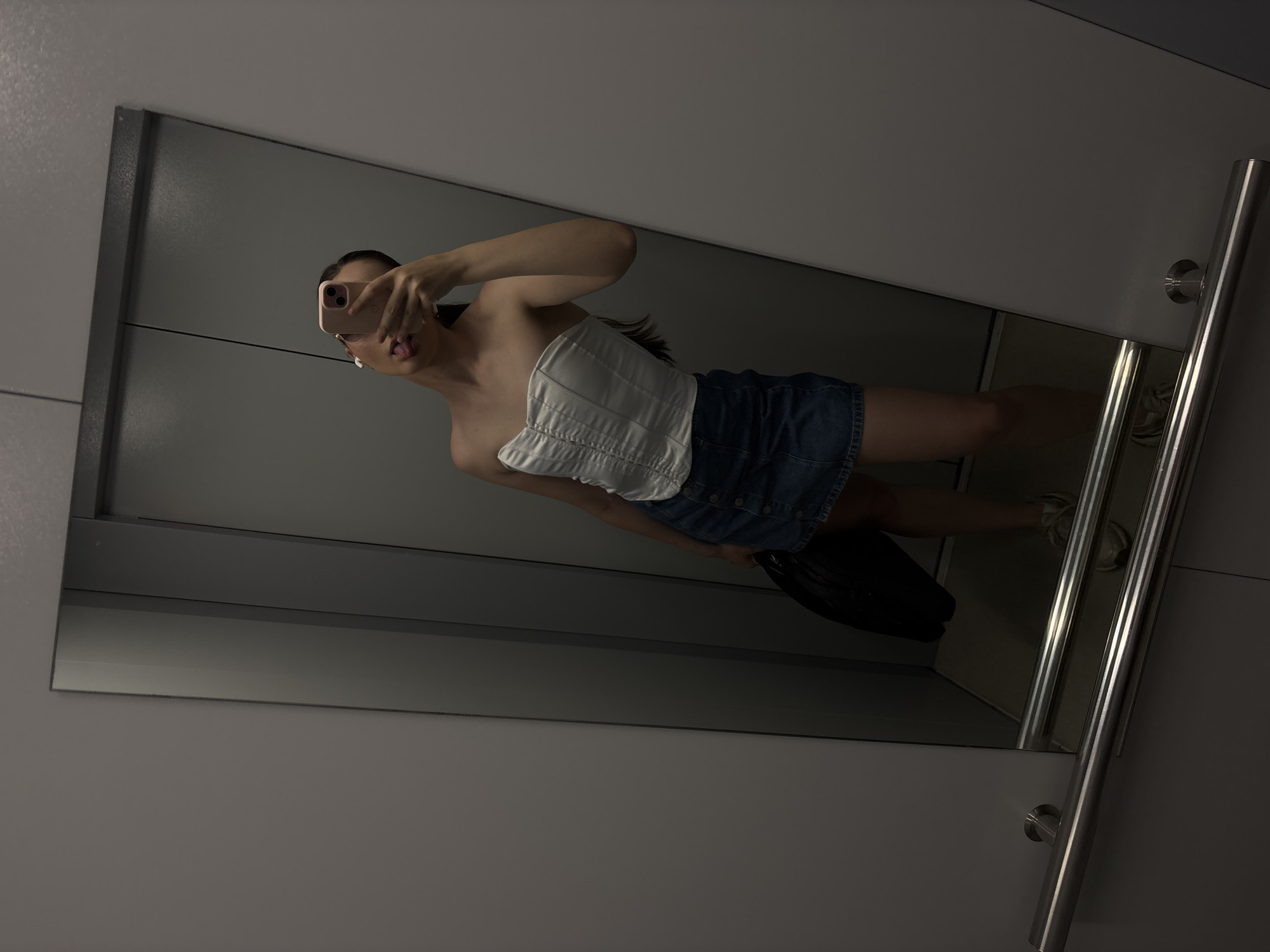 Mirror selfies, white top and dark bottoms, minutes apart