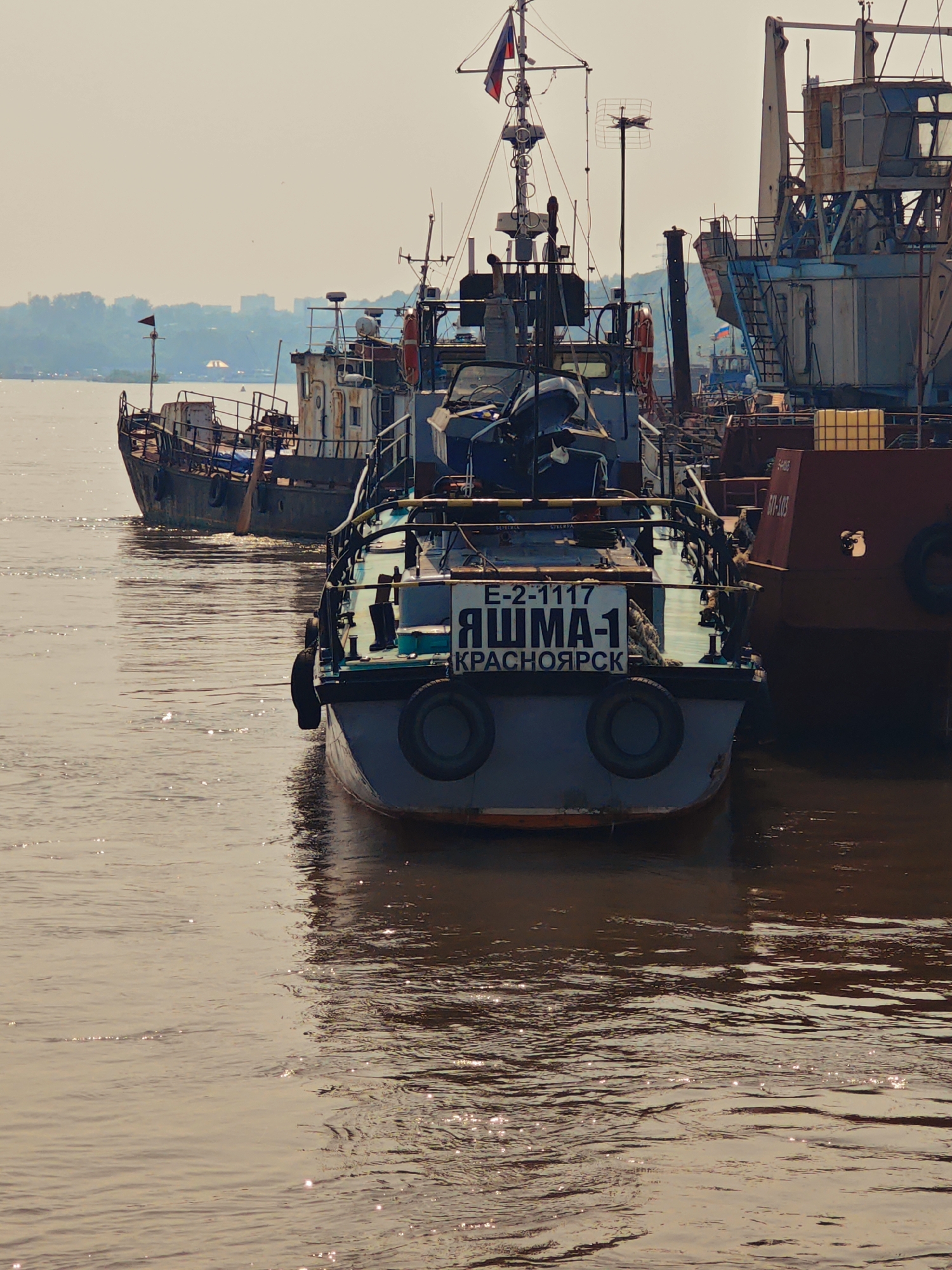 Cargo ships on the Yenisei and a moth on a hand, Krasnoyarsk