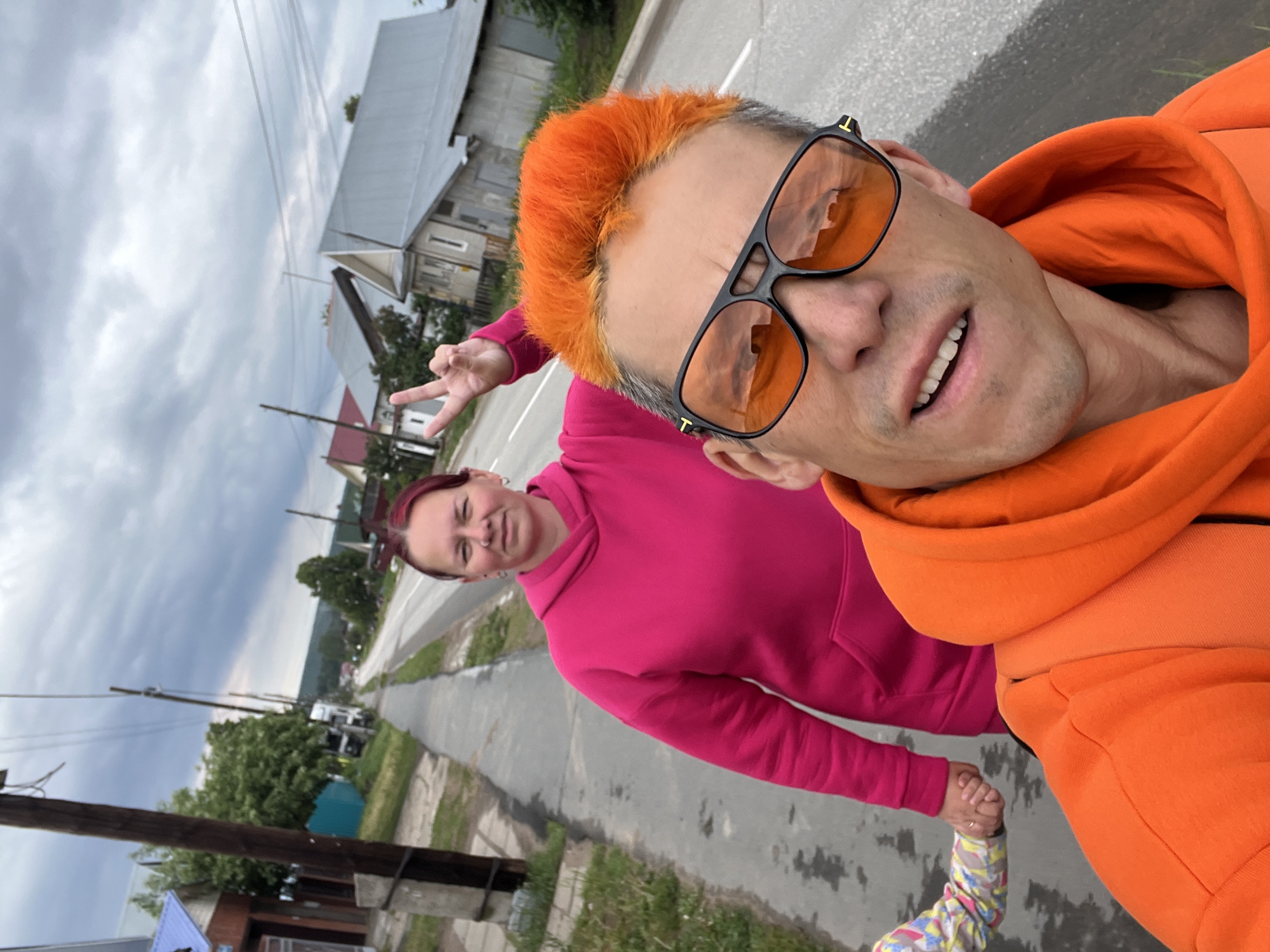 Family in orange outfits plays in puddles in Chaikovsky