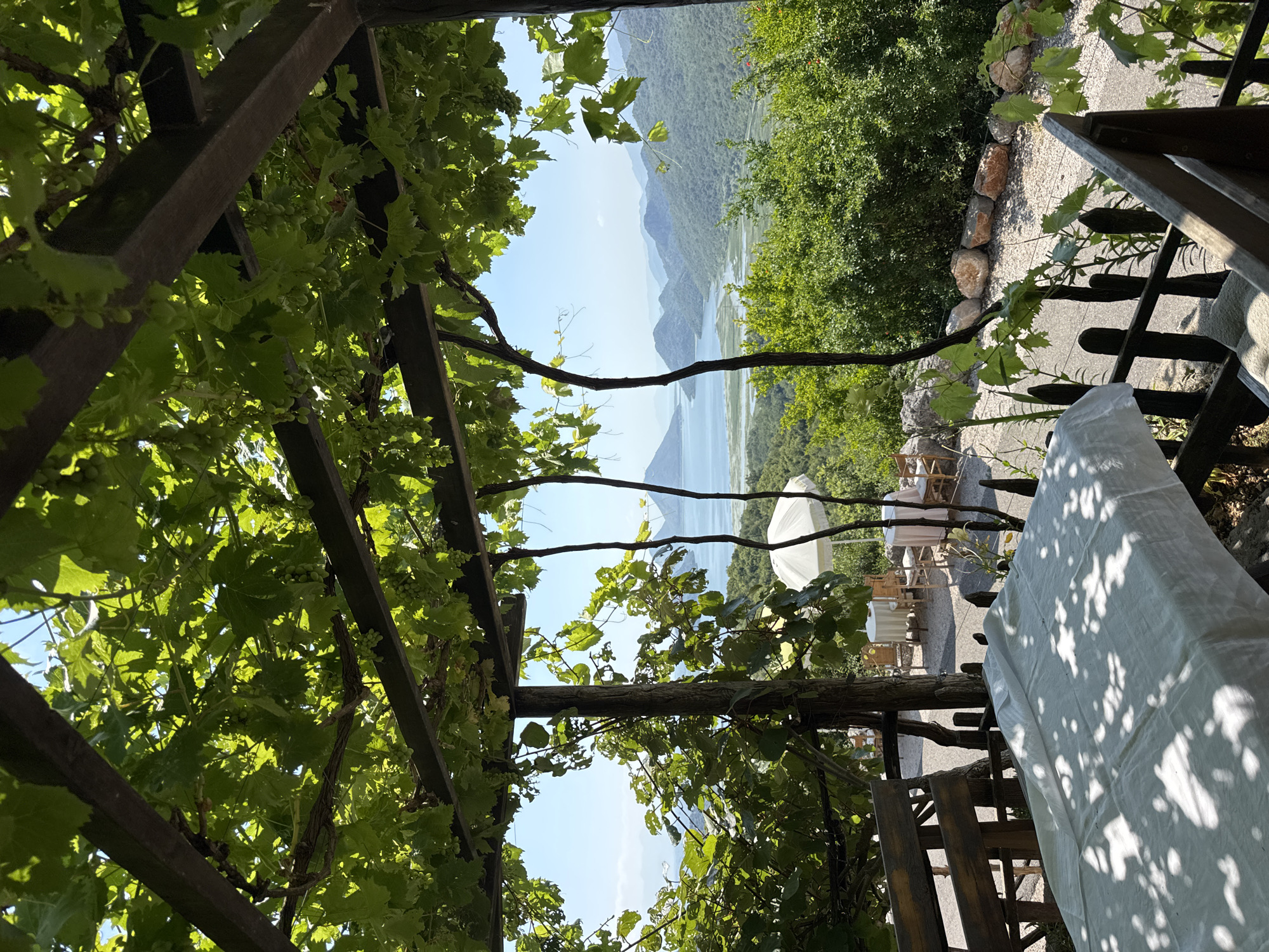 Lazy morning by an old stone bridge, water, and outdoor dining