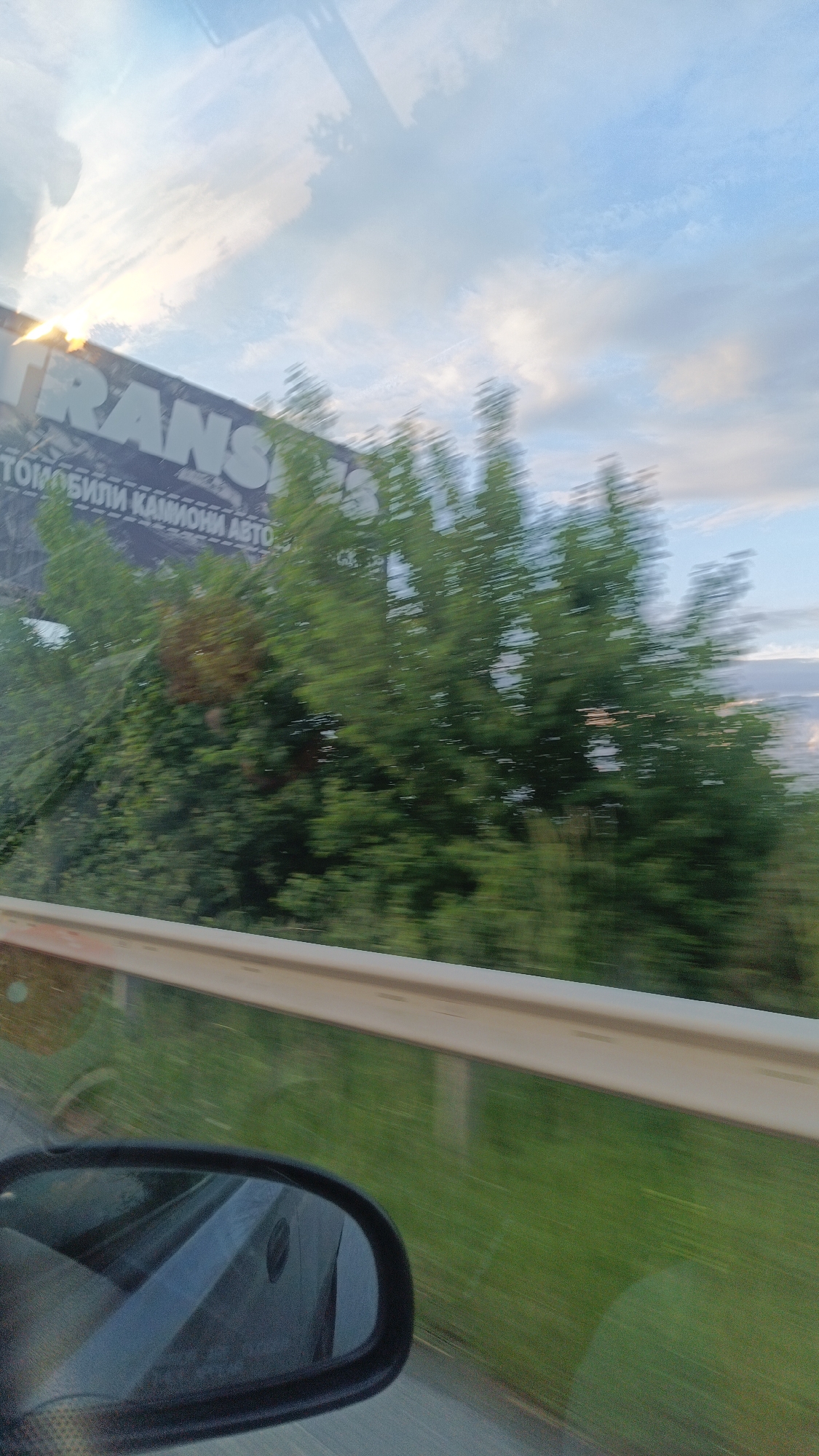 Blurred roadside scene photographed from moving vehicle in Burgas