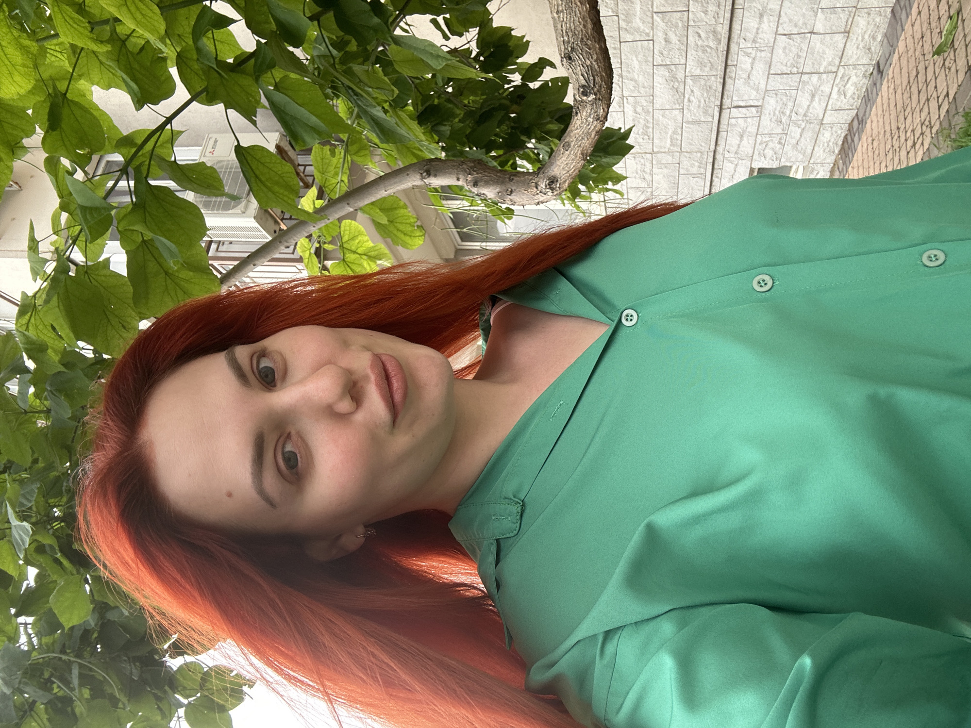 Selfie series on a sunny Odesa walkway, green outfit and red hair.