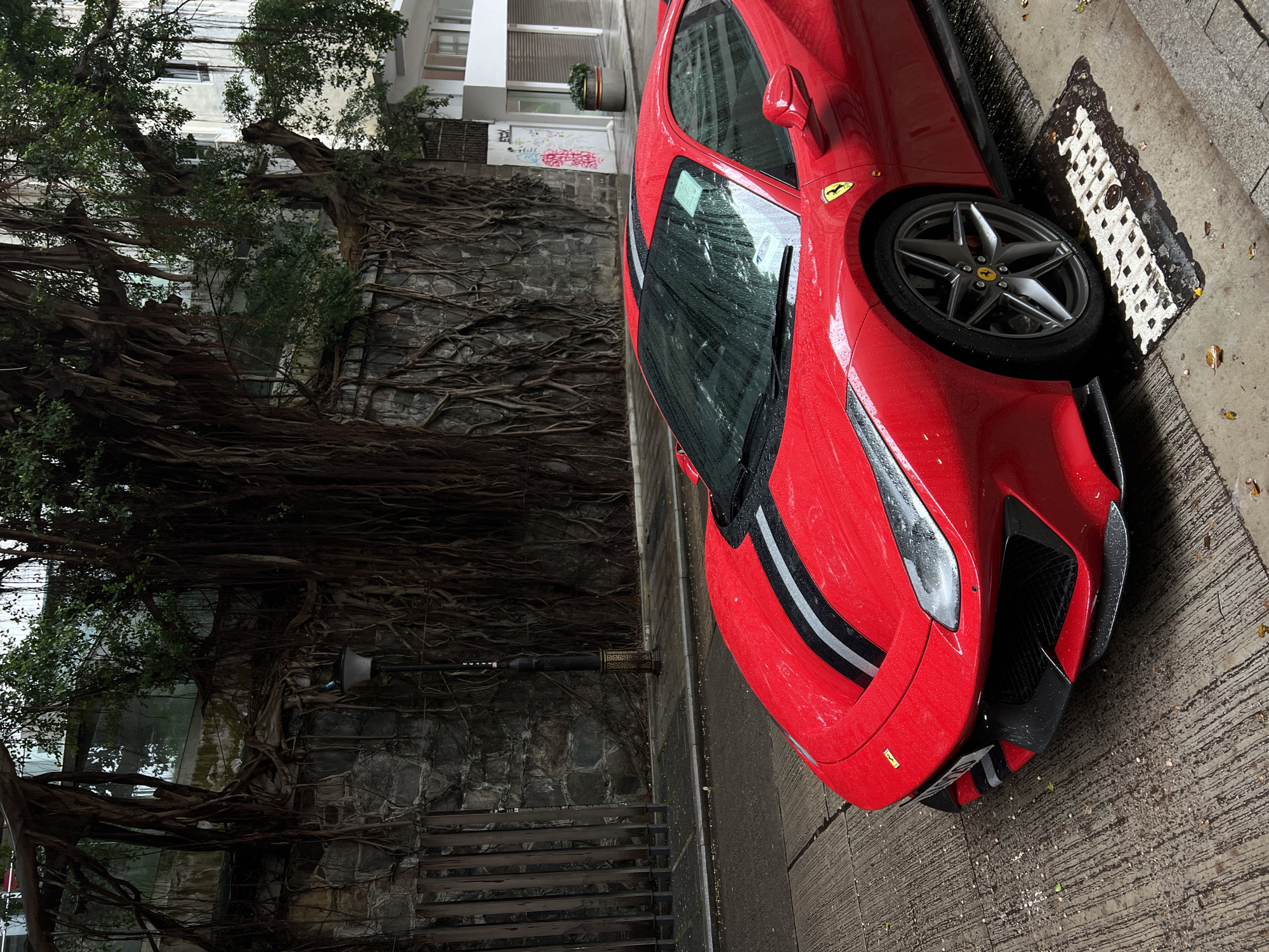 Red Ferrari spotted on wet Hong Kong street