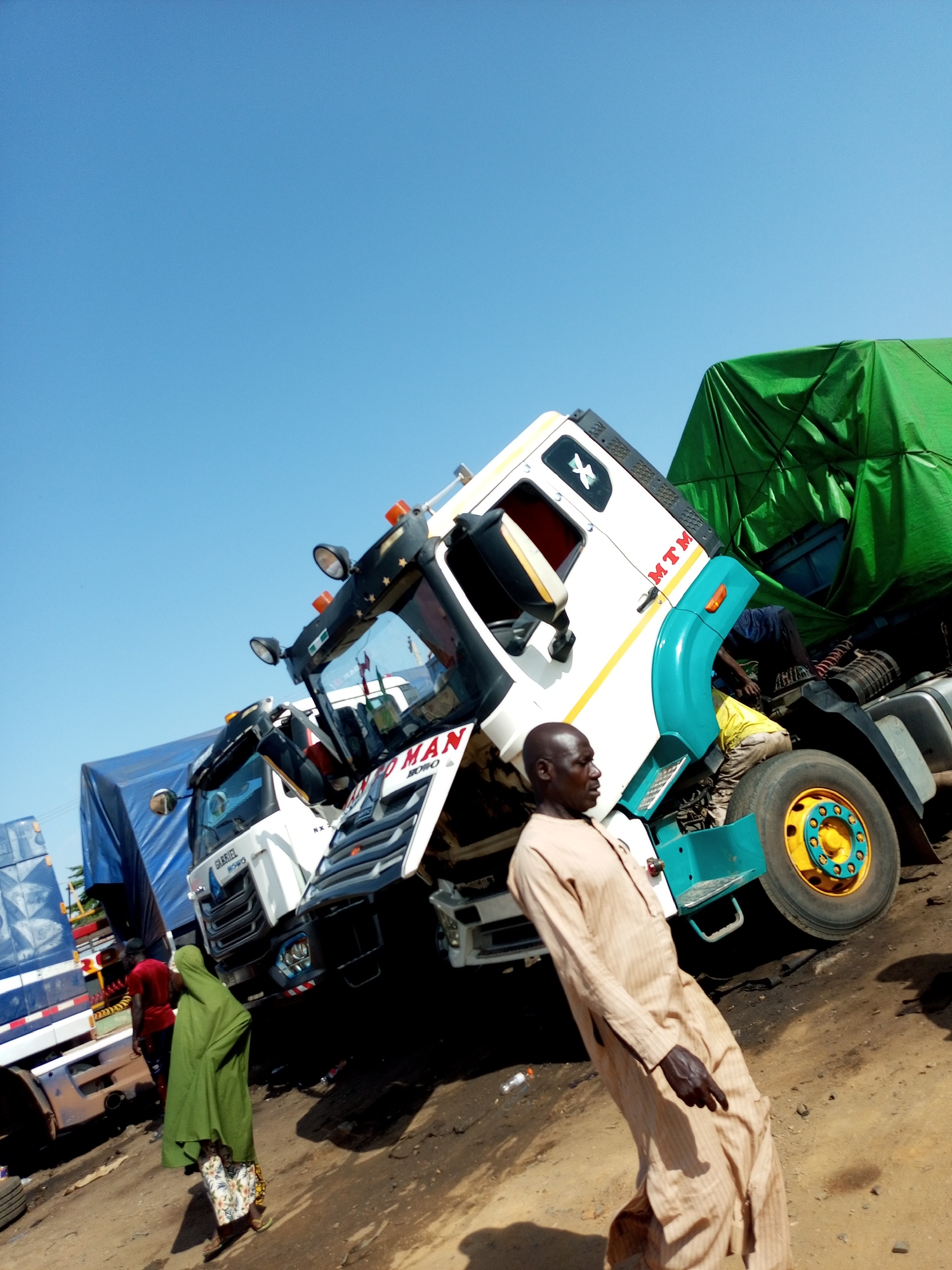 Trucks and market life in an African outdoor setting