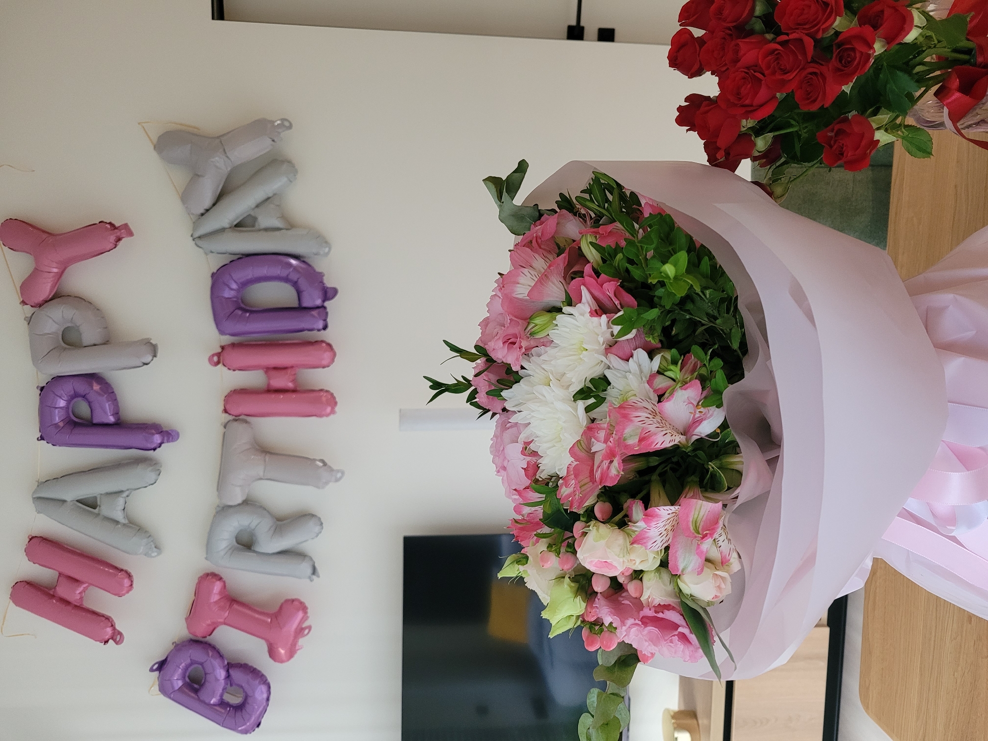 Birthday flowers and balloons arranged for a celebration