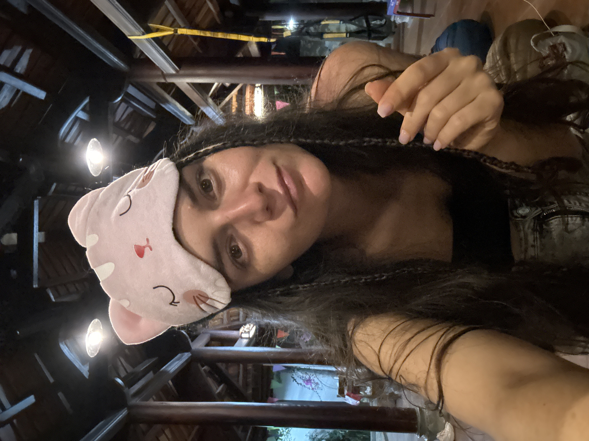 Woman photographed with pink cat mask in Mũi Né indoor space