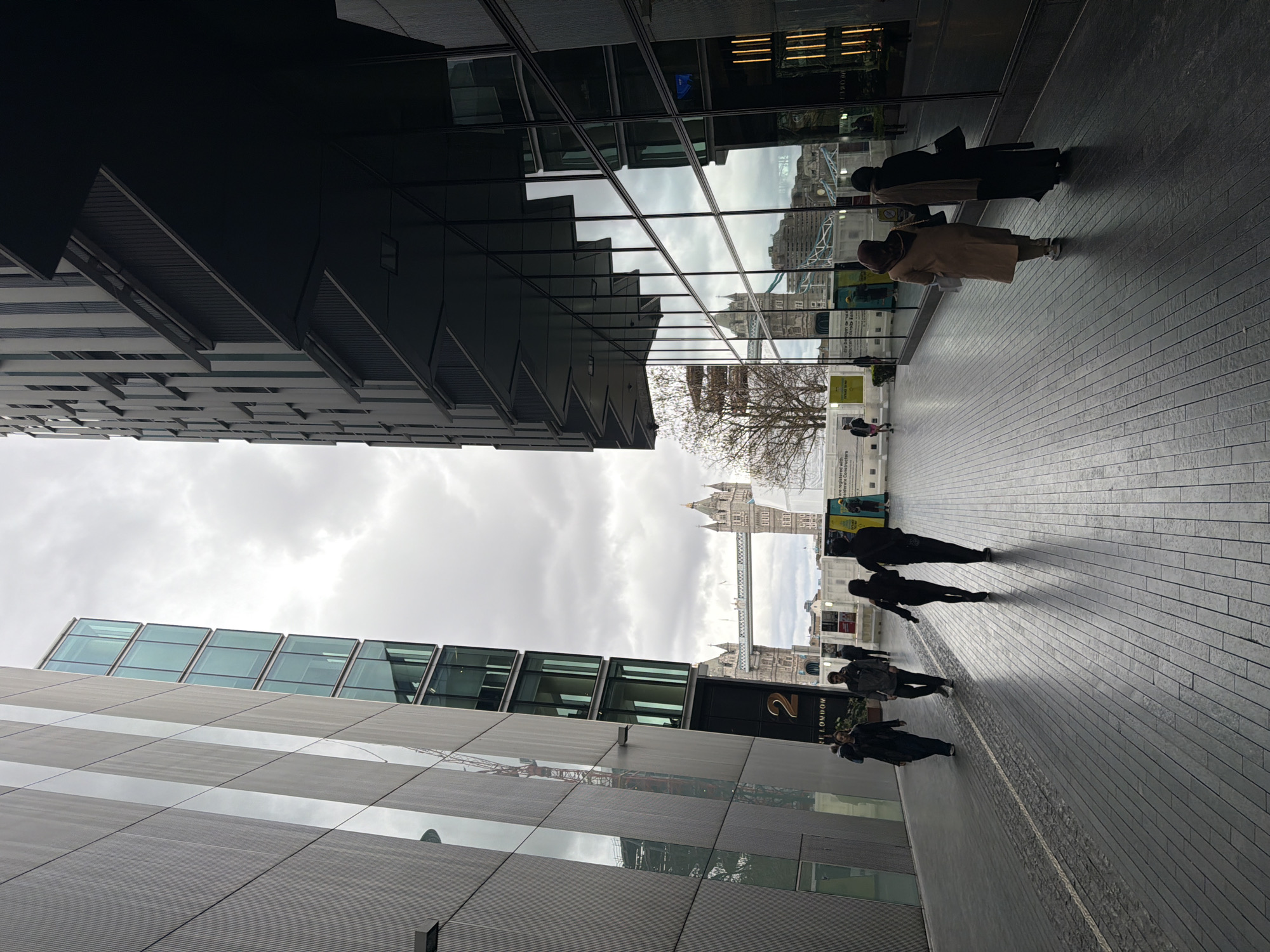 London street scene captures Tower Bridge between modern buildings
