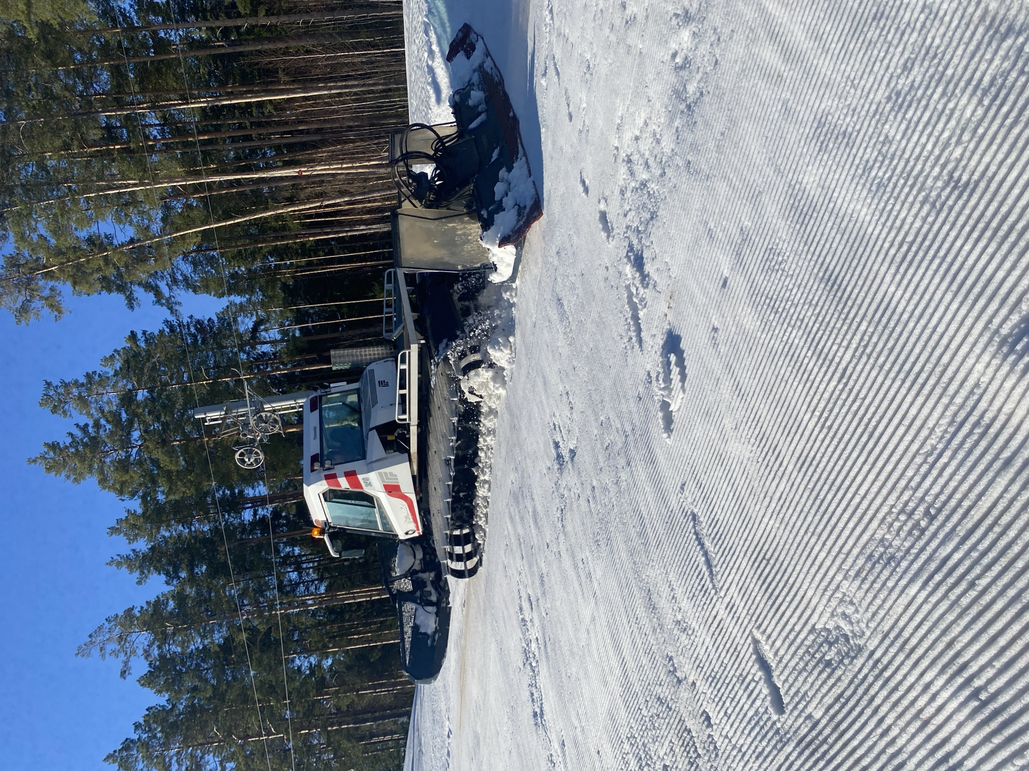 Snow groomers prepare ski slopes in Russian resort