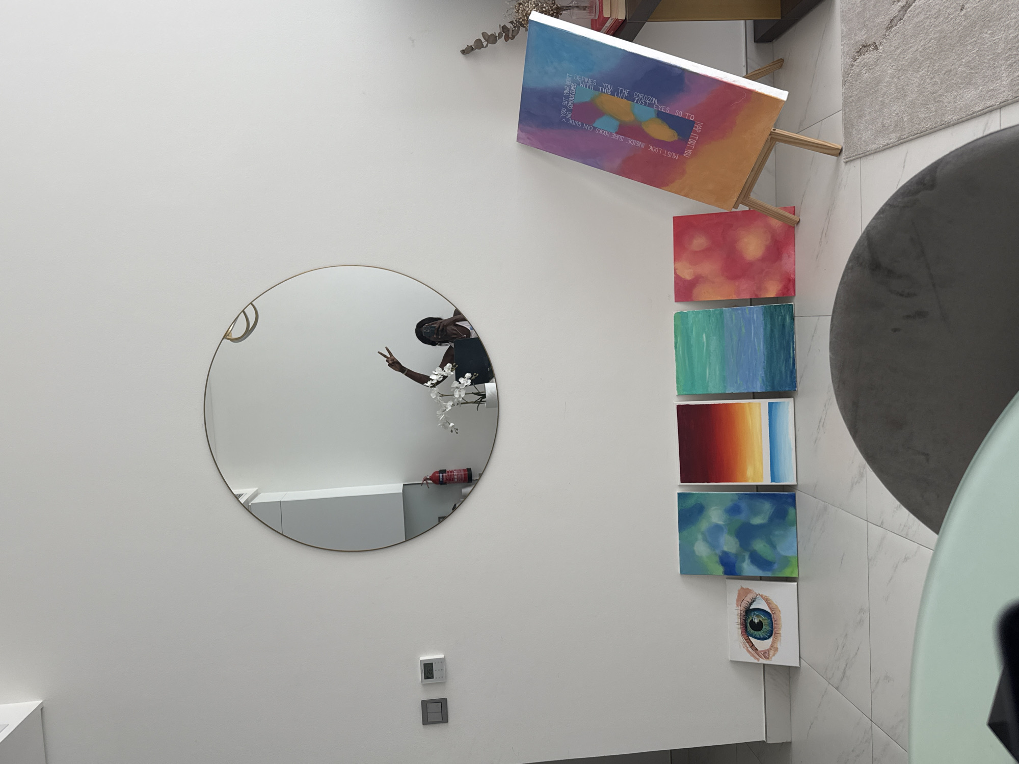 Person makes peace sign in mirror reflection, Dubai interior