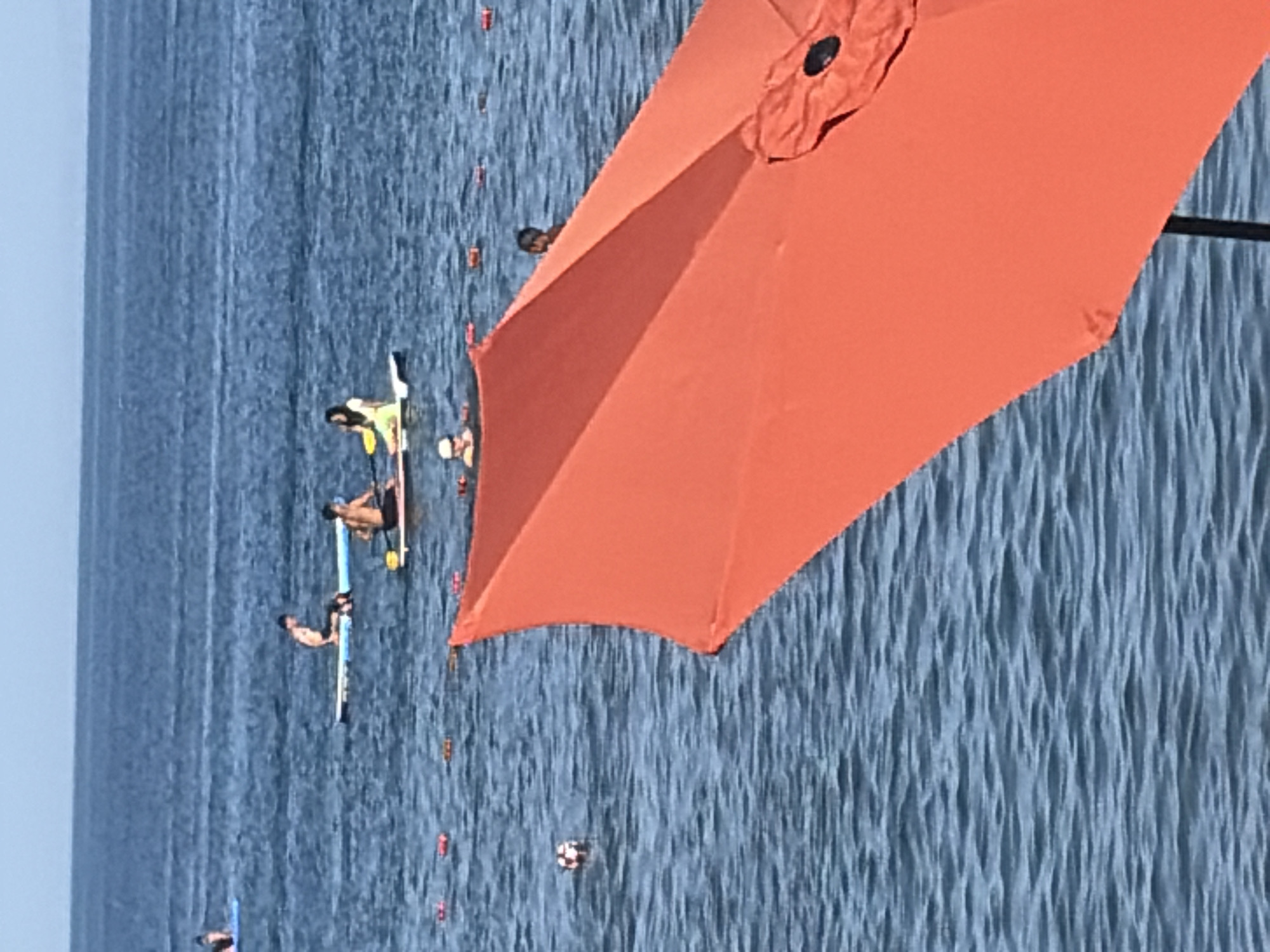 A lively beach day with paddleboarding, kayaking, and waterside lounging
