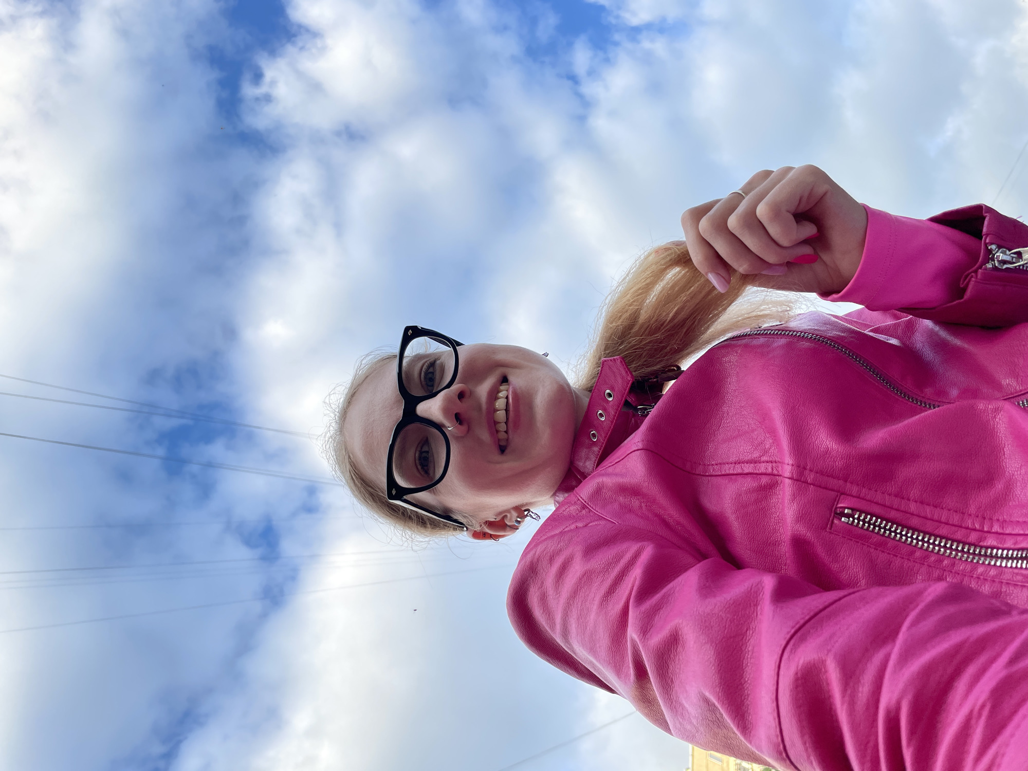 Woman photographs herself among pink peonies in Izhevsk