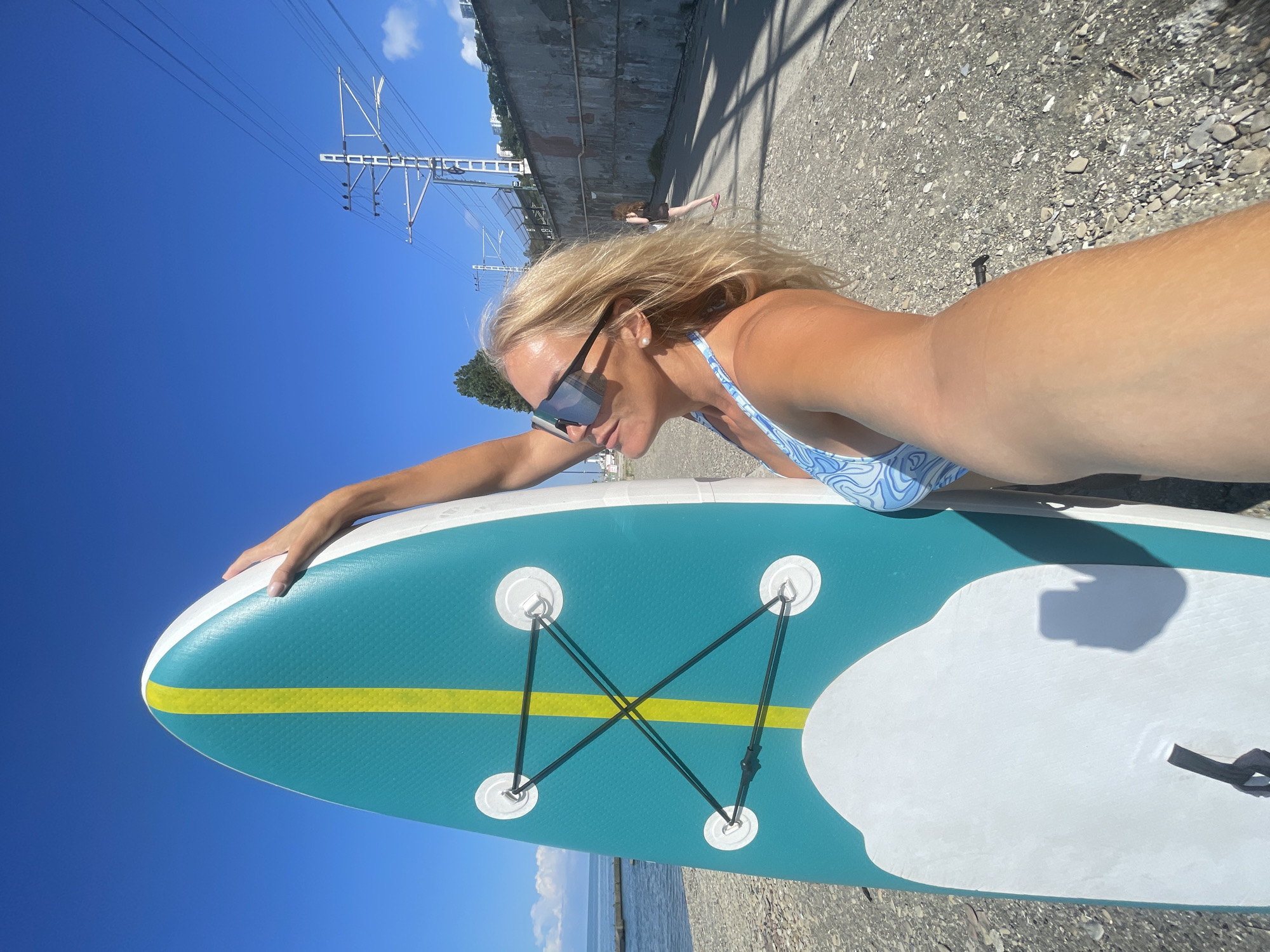 Paddleboard day on a sunny Sochi pebble beach