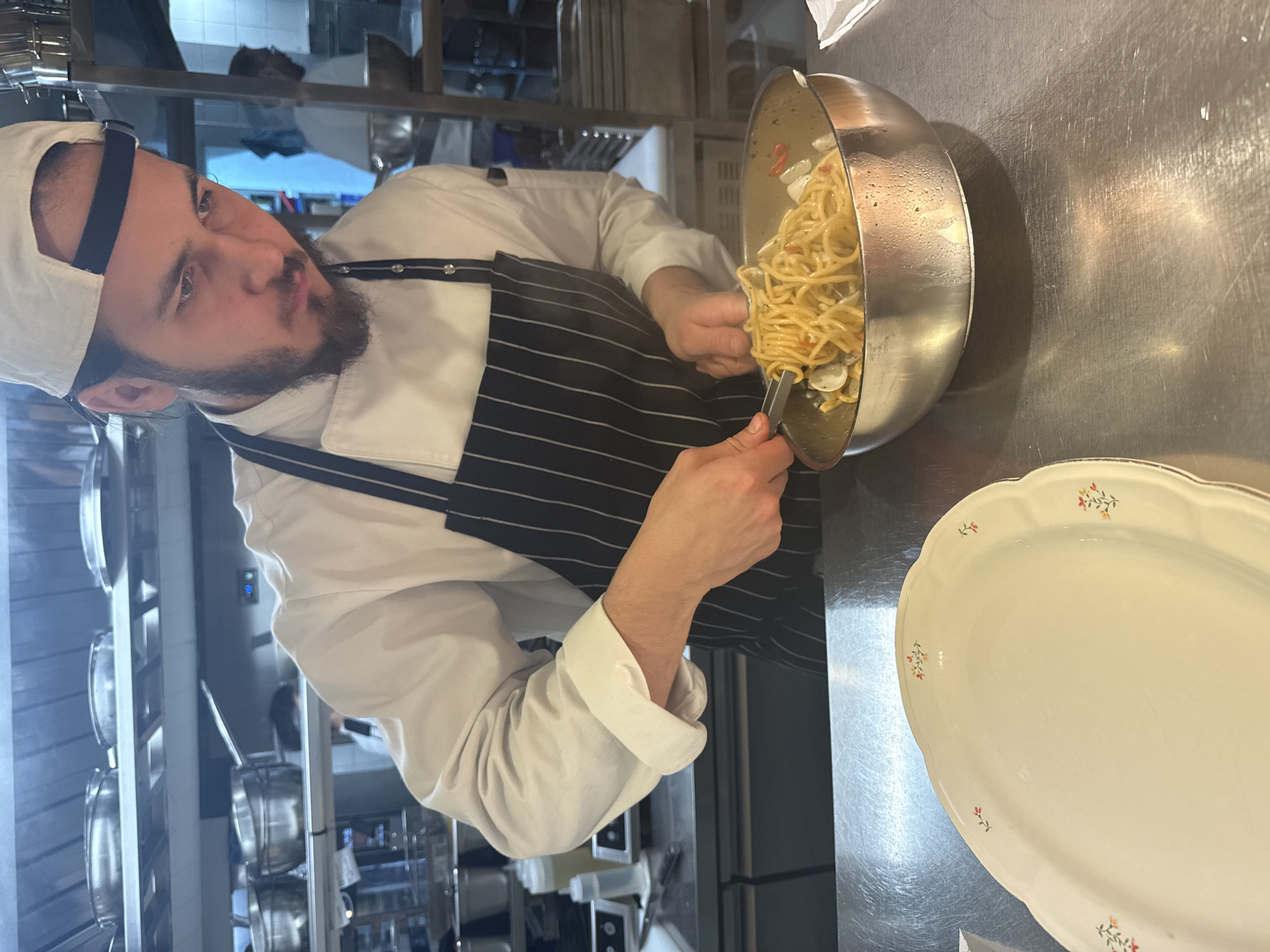 Chef prepares plated dishes in professional kitchen