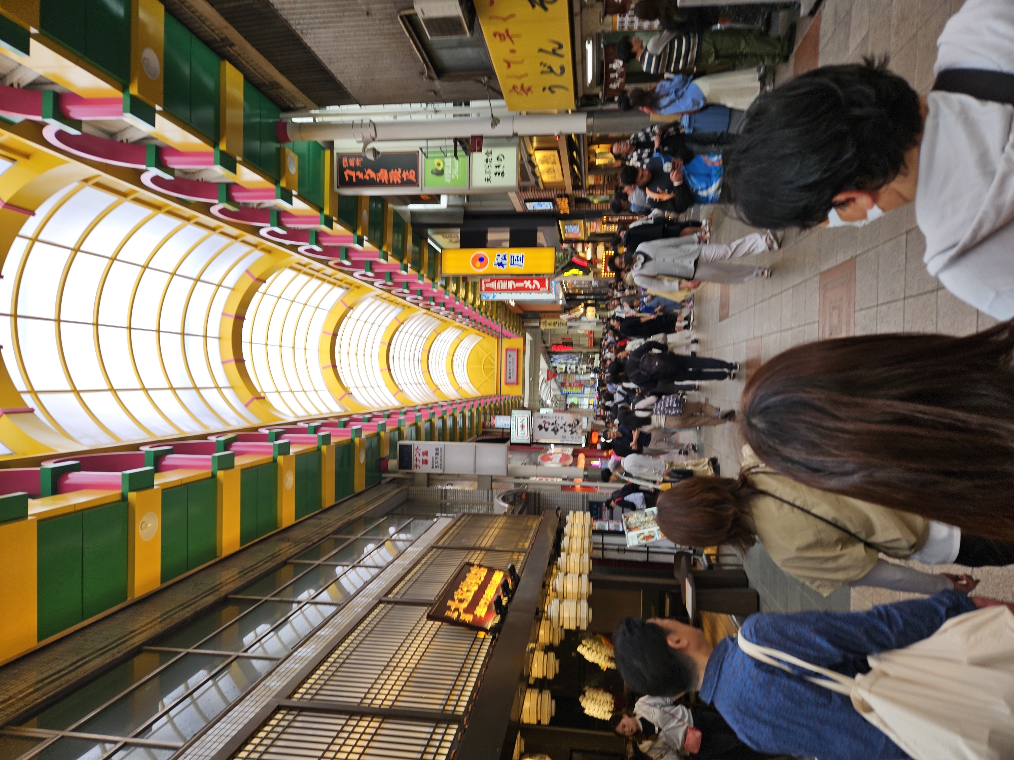 Tourist documents brief walk through Japanese arcade and shops