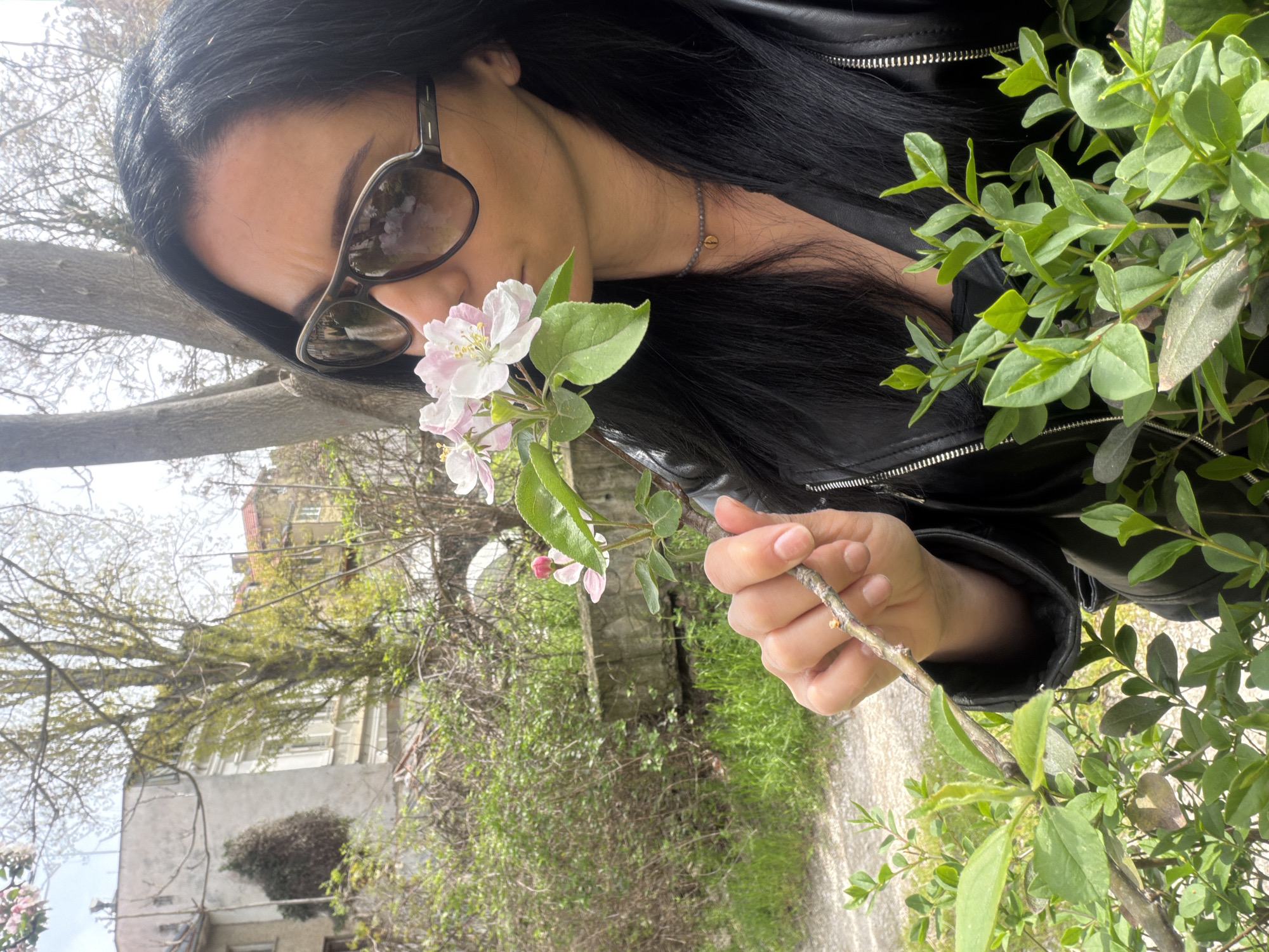 Woman enjoys spring blossoms in Pleven park