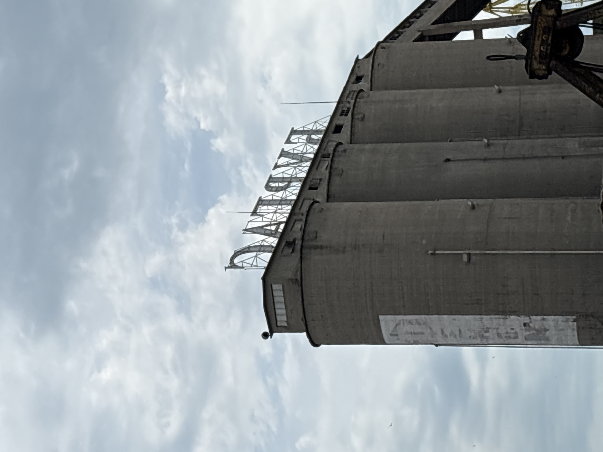 Industrial harbor scenes: cargo ships, grain silos, and dockside detail