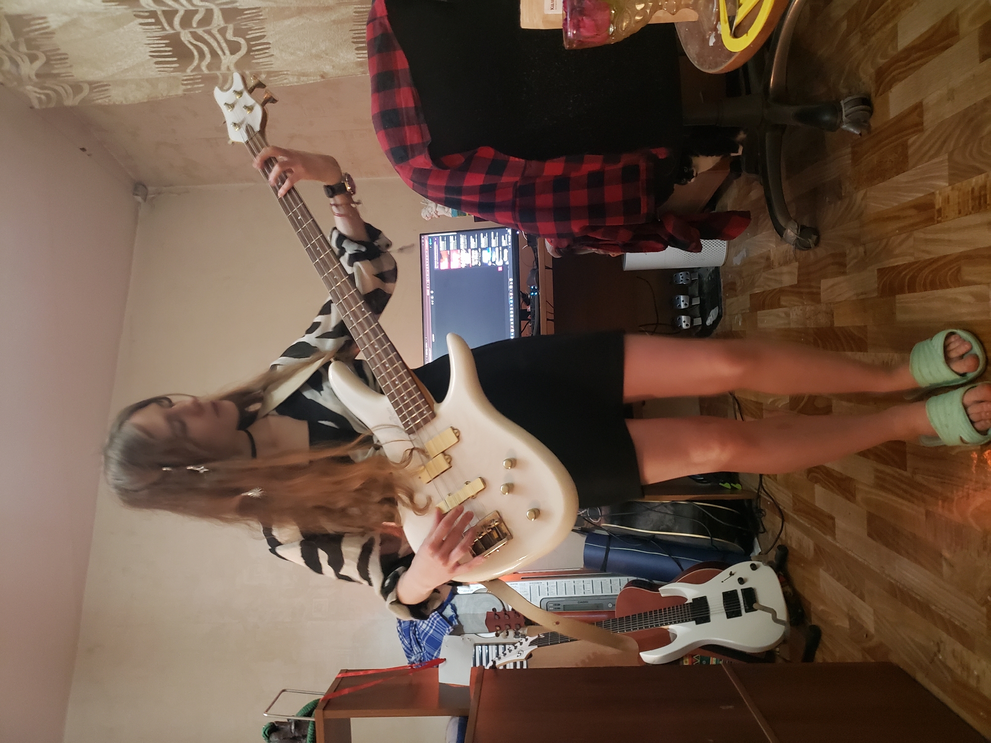 Barefoot bass guitar session in a casual indoor setting