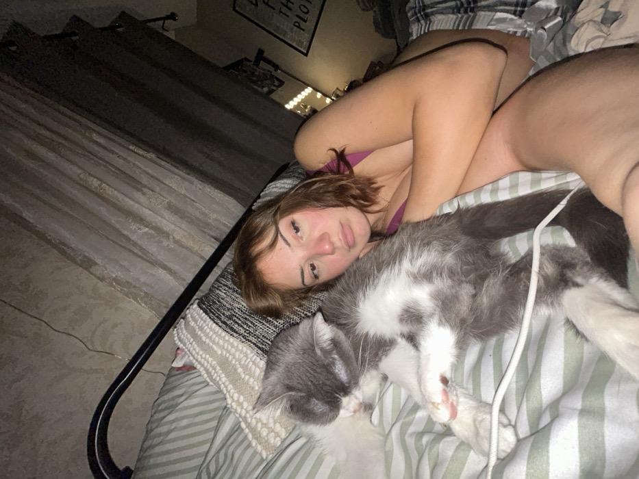 Woman spends evening relaxing in bedroom with cat in France