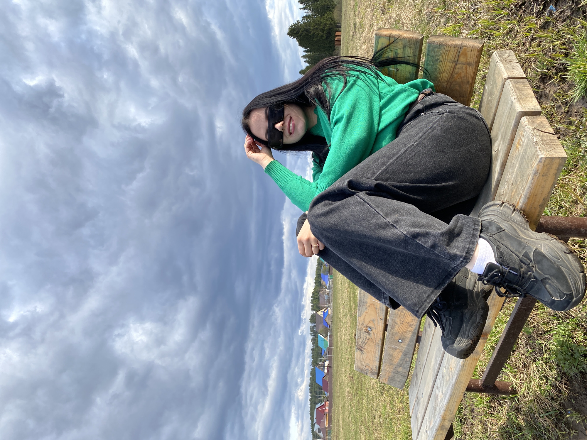 Woman in green sweater photographed at multiple outdoor spots
