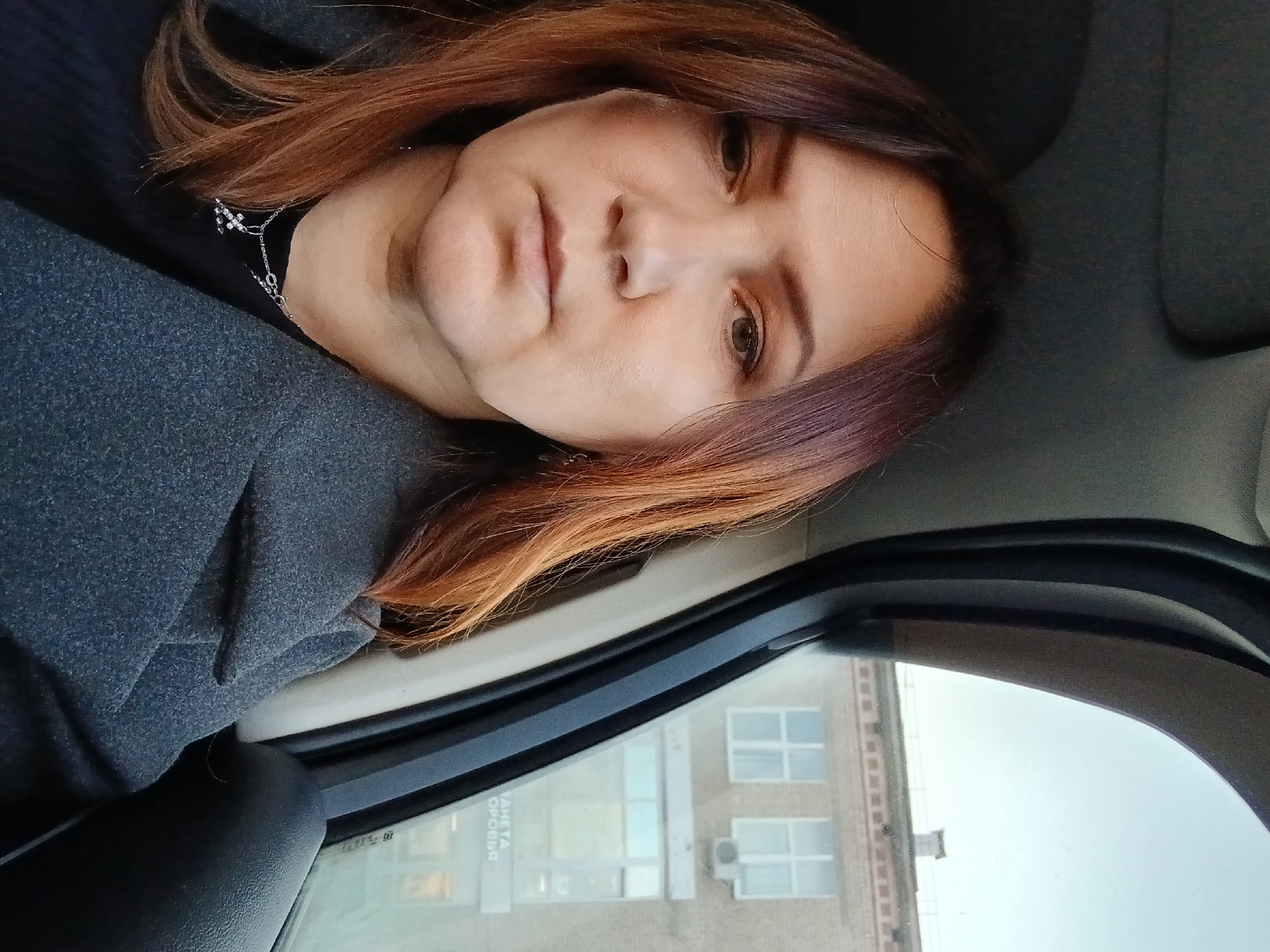 Woman photographed in vehicle during urban daytime incident