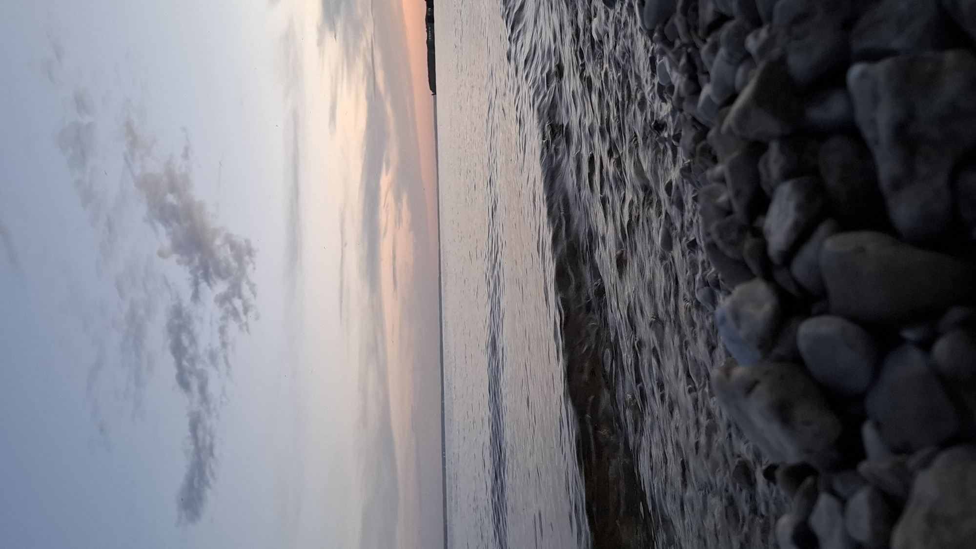 Dusk to moonlit night at a quiet beach shoreline