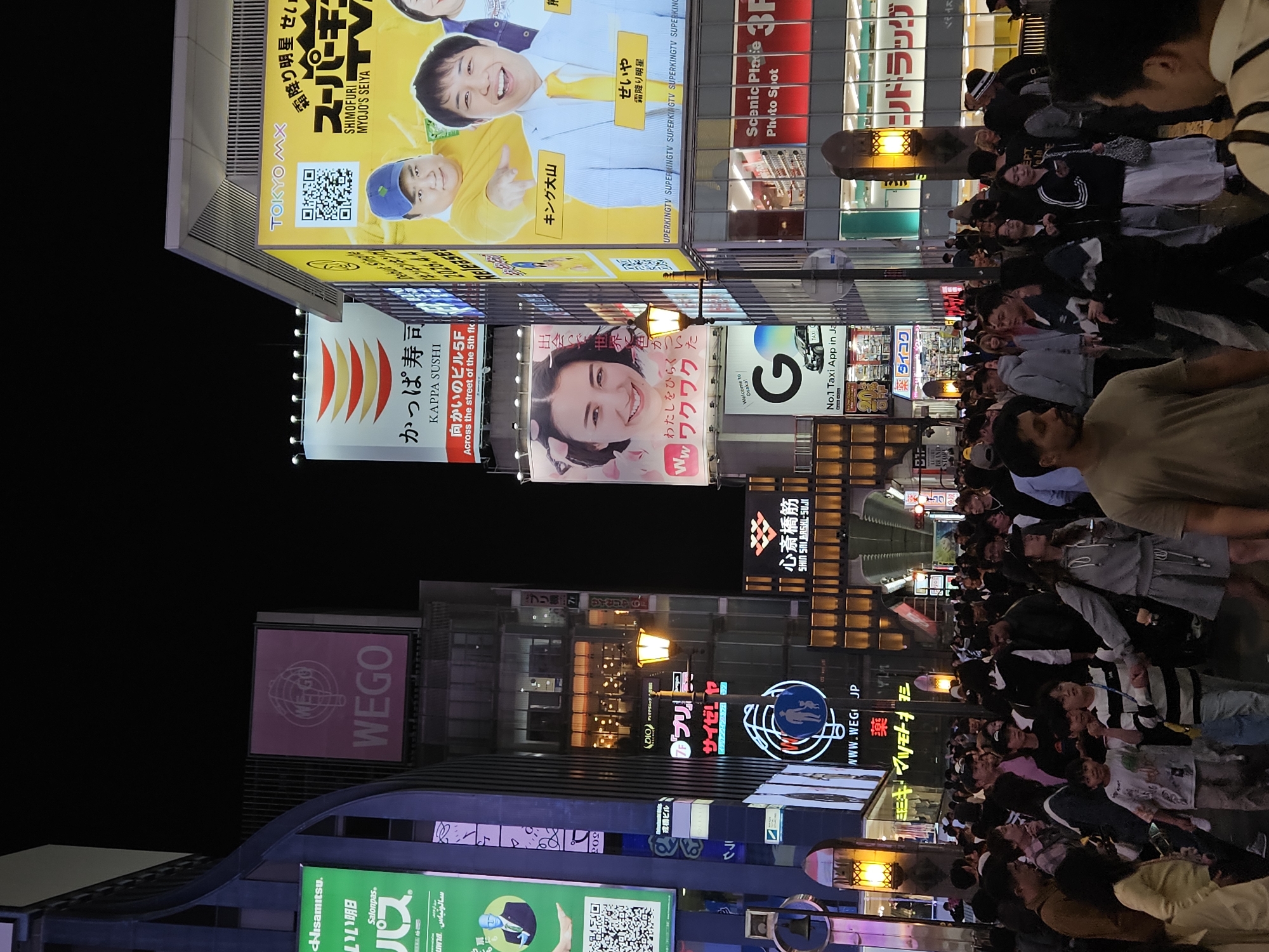 Busy nighttime commercial district captured in Osaka