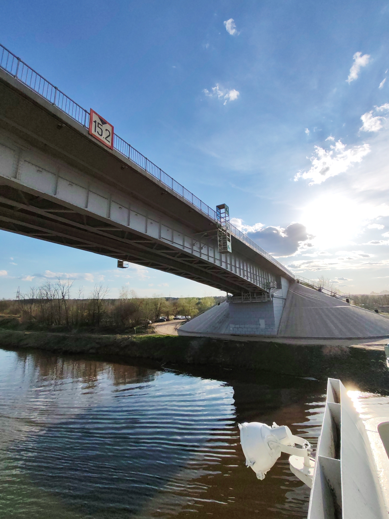 River traffic passes under highway bridge in Podosinki, Russia