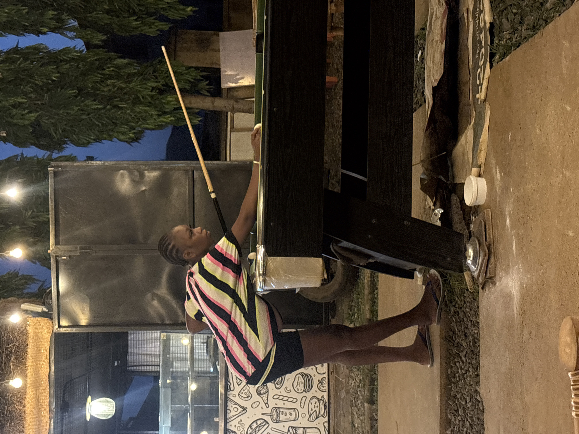 Evening billiards game at outdoor salon in Dutsen Alhaji