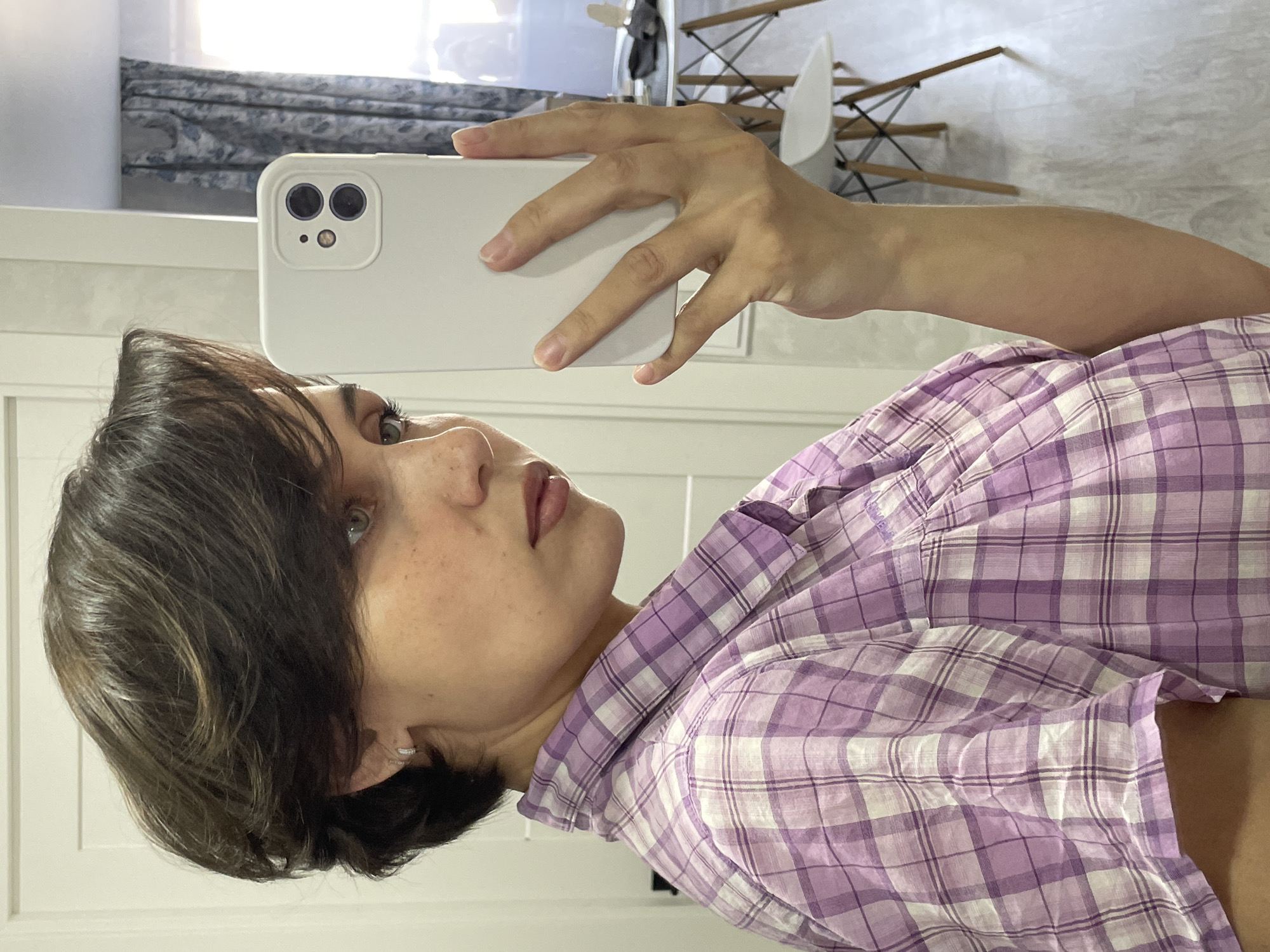 Woman takes early morning selfies in Izhevsk bedroom