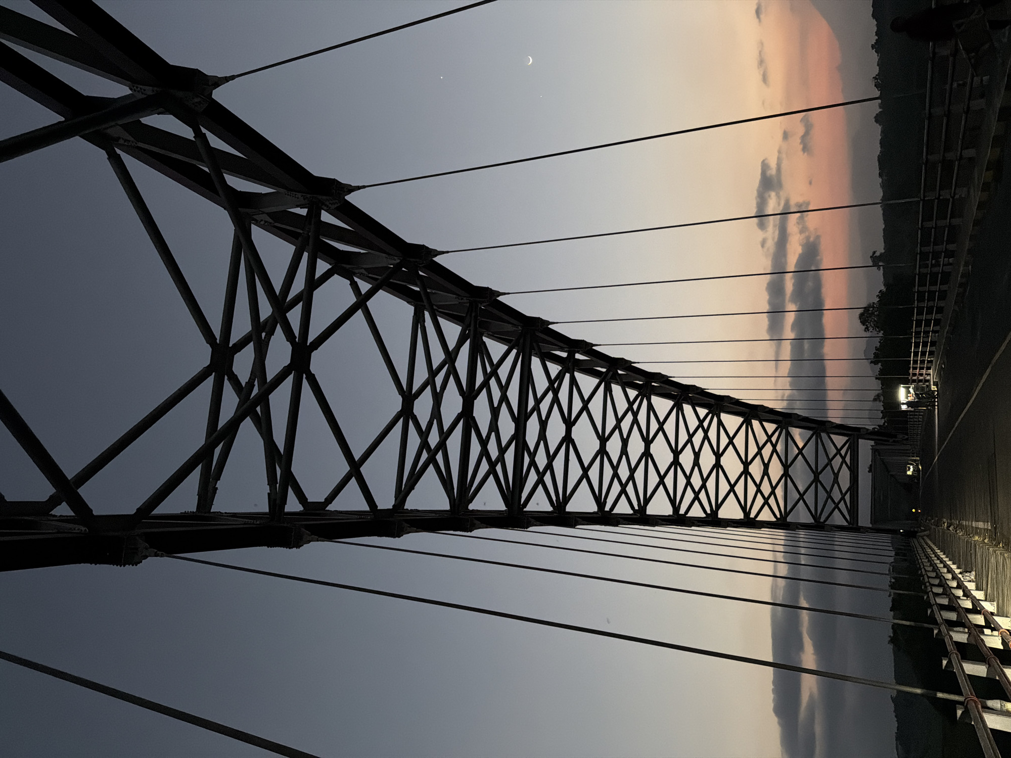 Suspension bridge at dusk, Selokanayar — steel and fading sky