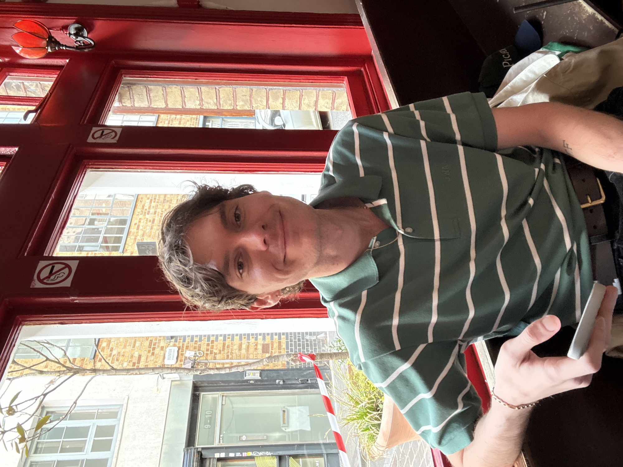 Man photographed smiling indoors in London