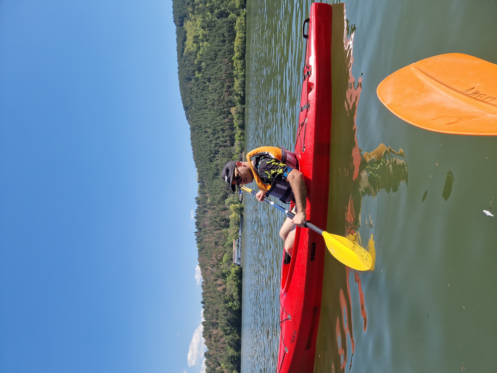 Two kayakers paddle on Pancharevo Lake, Bulgaria morning session